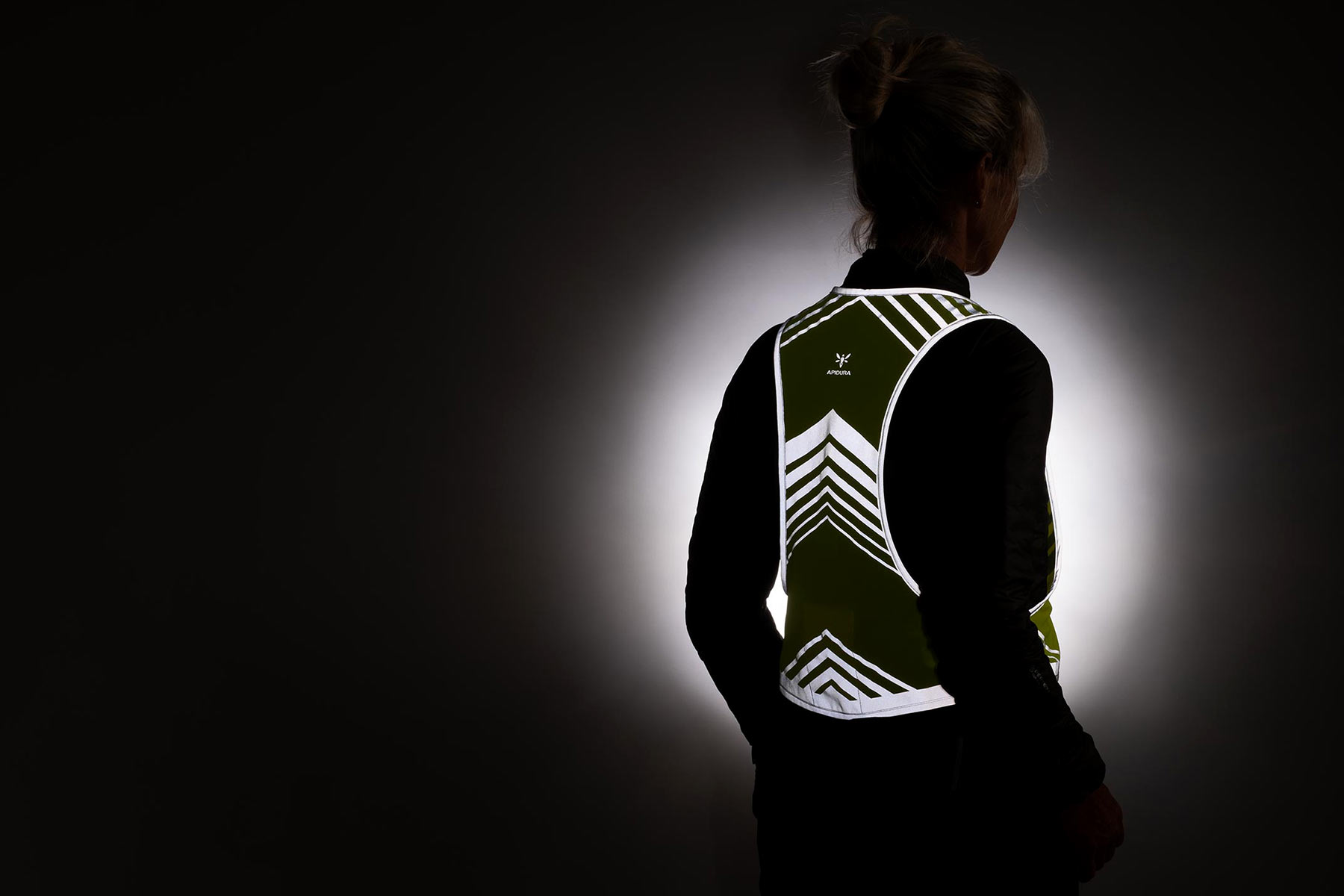 Apidura Packable Visibility Vest, lightweight road cycling-fitted EN Certified hi-viz vest in the dark