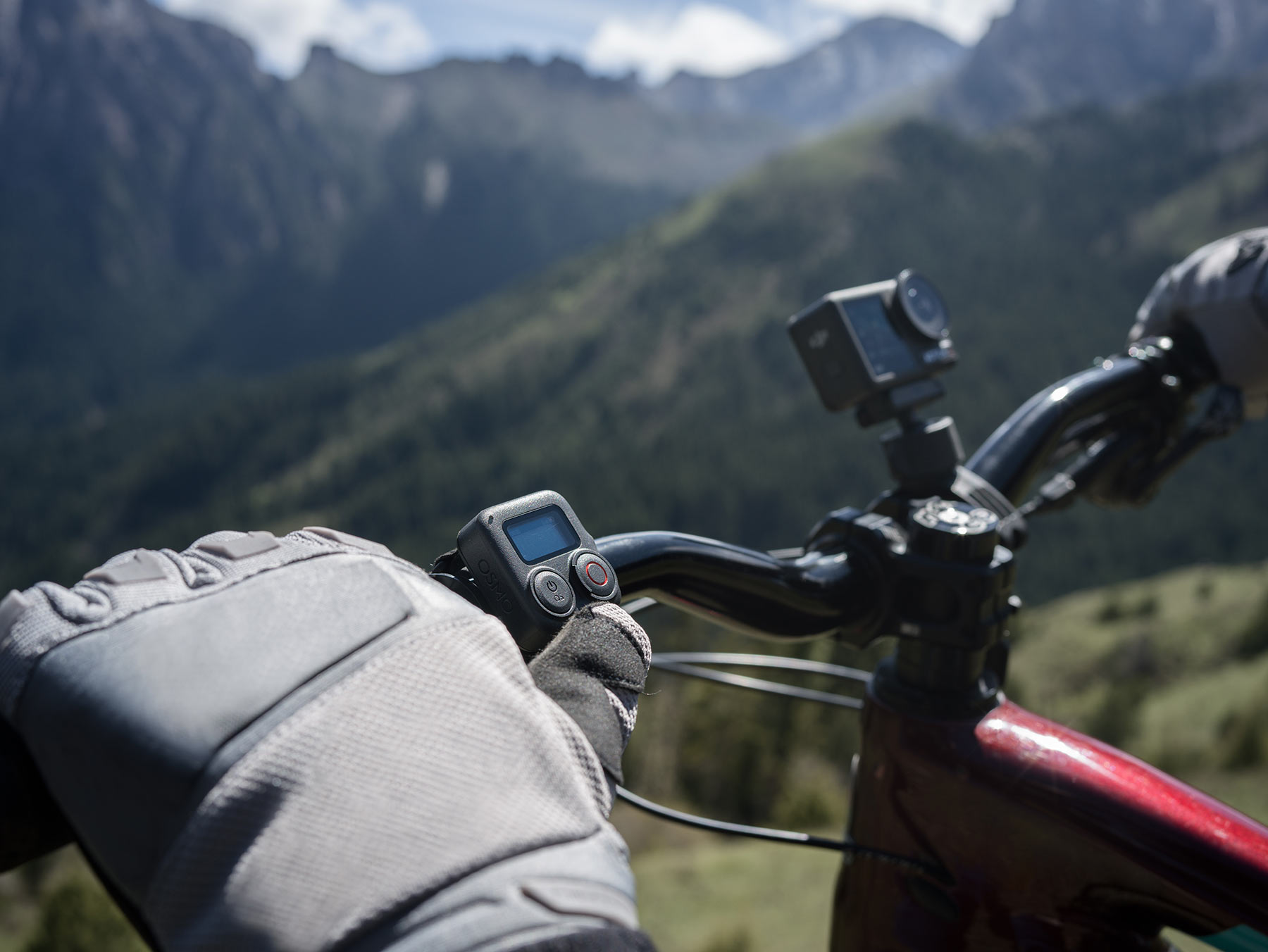 DJI Osmo Action 4 camera shown with GPS bluetooth remote on a MTB handlebar