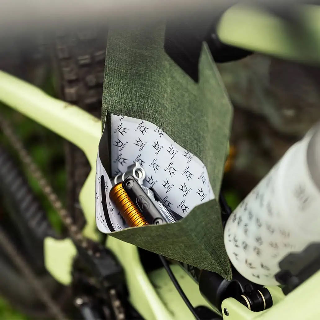 peaty's holdfast trail tool wrap hanging from a top tube