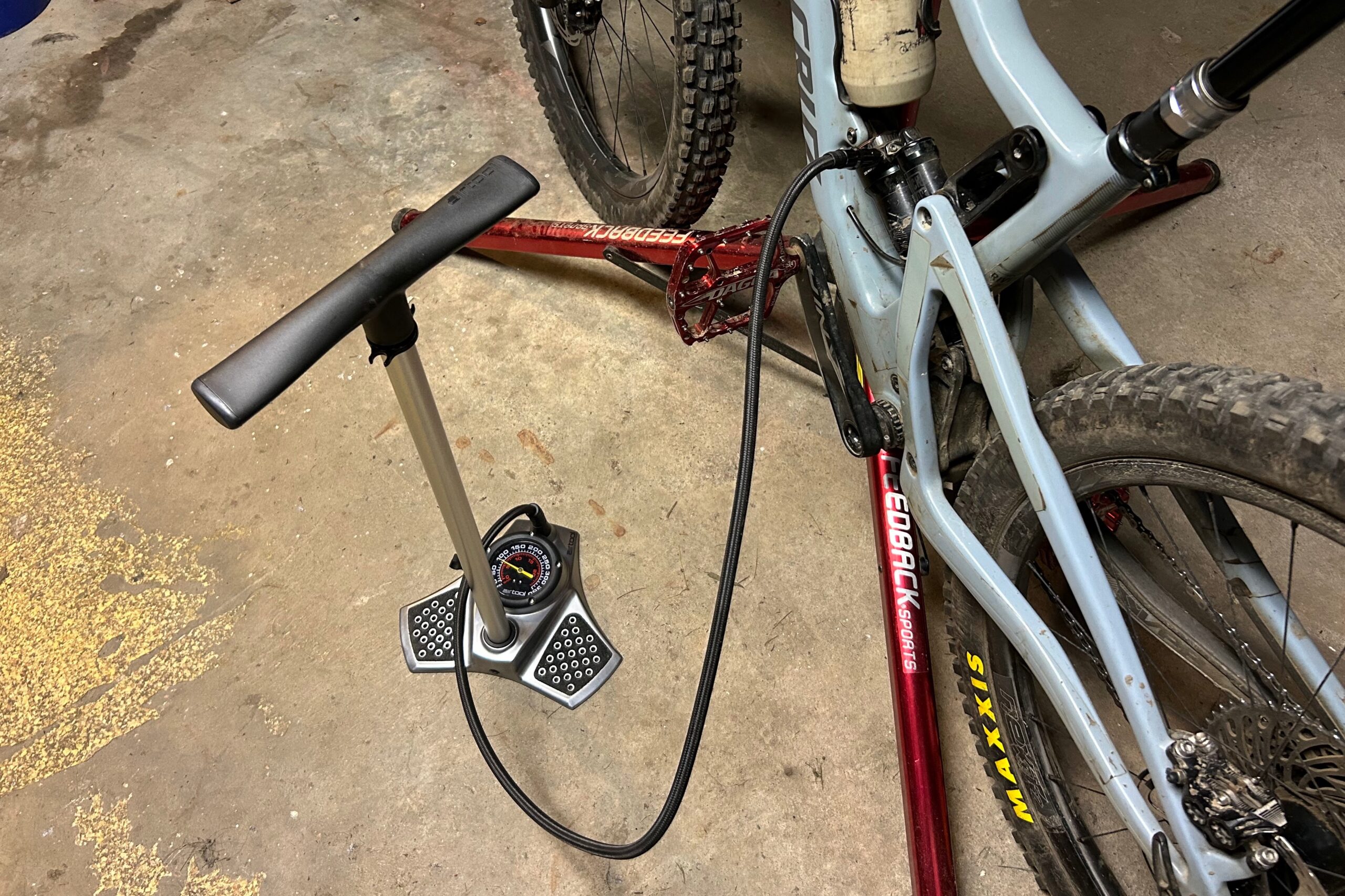 Specialized Air Tool UHP bike pump attached to a rear shock in the home workshop