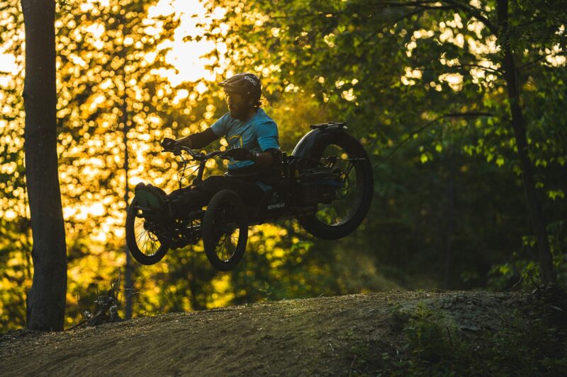 GREG DURSO riding an adaptive mountain bike on driving range trails in Vermont