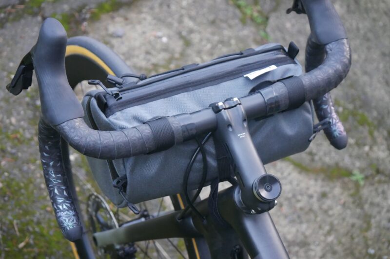 The Road Runner Bags West Coast Burrito Handlebar Bag mounted to a road bike handlebar