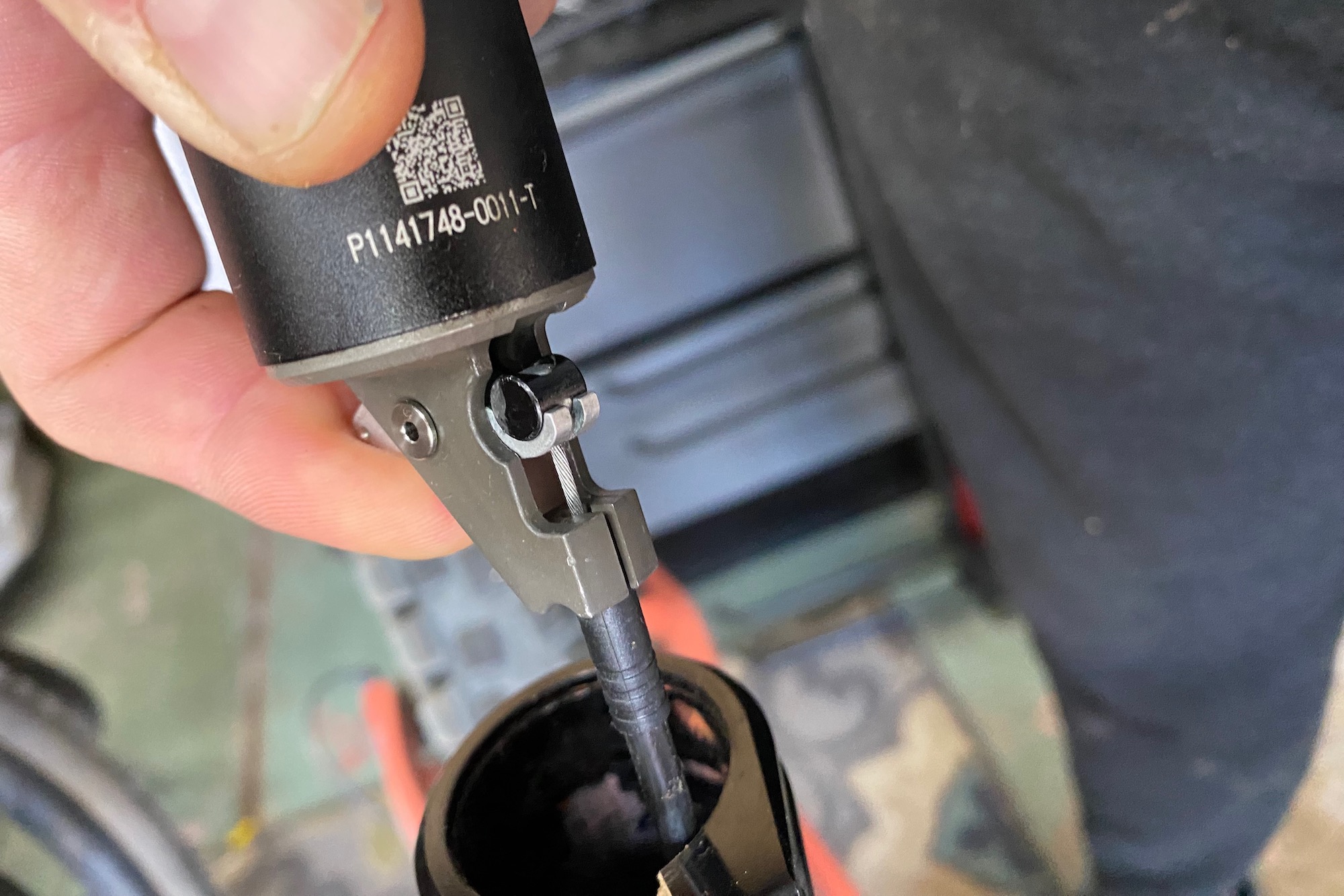 installing a dropper post with a close view of the actuator and cable connection.