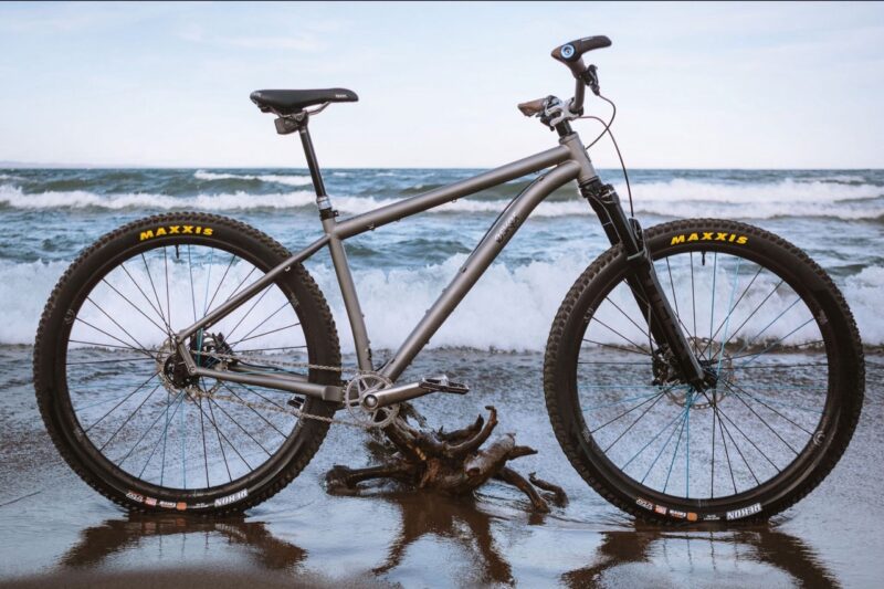 Eskar Cycles and Alexandria Houchin bike on the sand