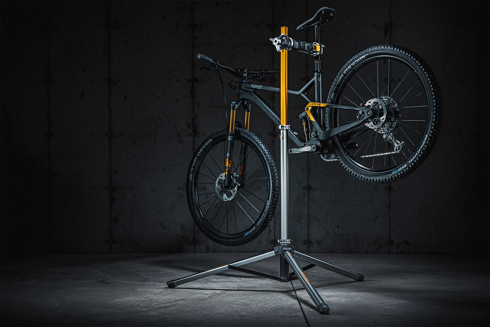 Feedback 20th Anniversary Limited Edition Pro Mechanic repair stand in gold & platinum, with a bike