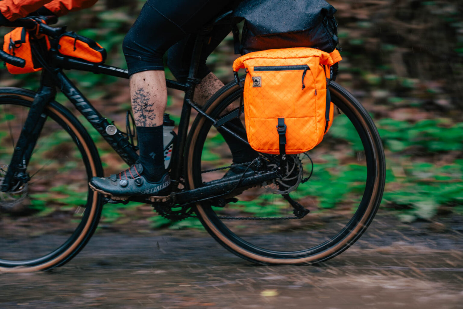 North St. Bikepacking bags, rider w orange pannier