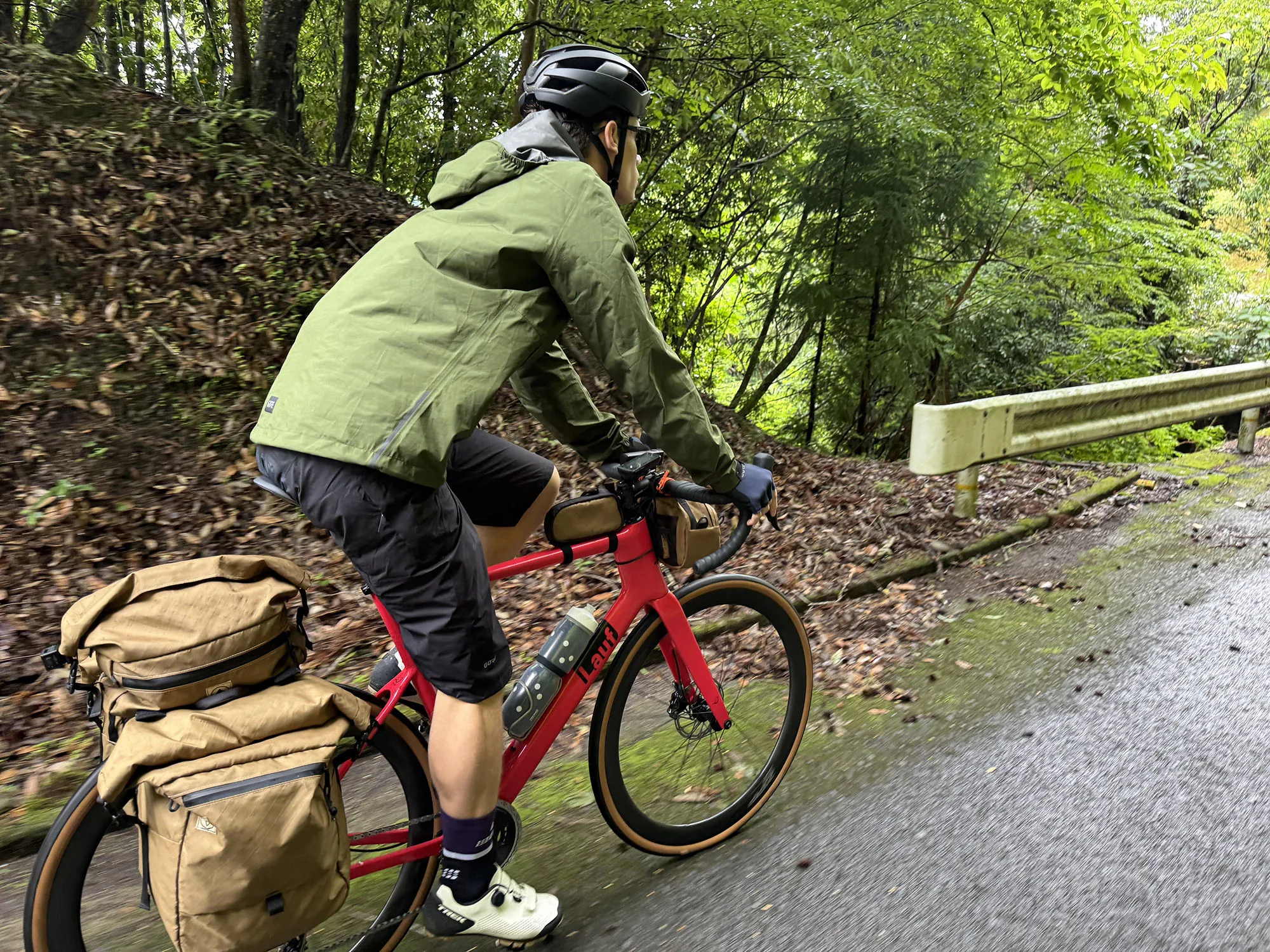 rider wearing gore mountain bike jacket and shell shorts.