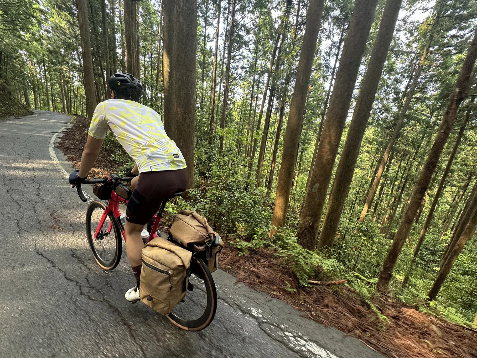 rider wearing gore mountain bike jacket and shell shorts.