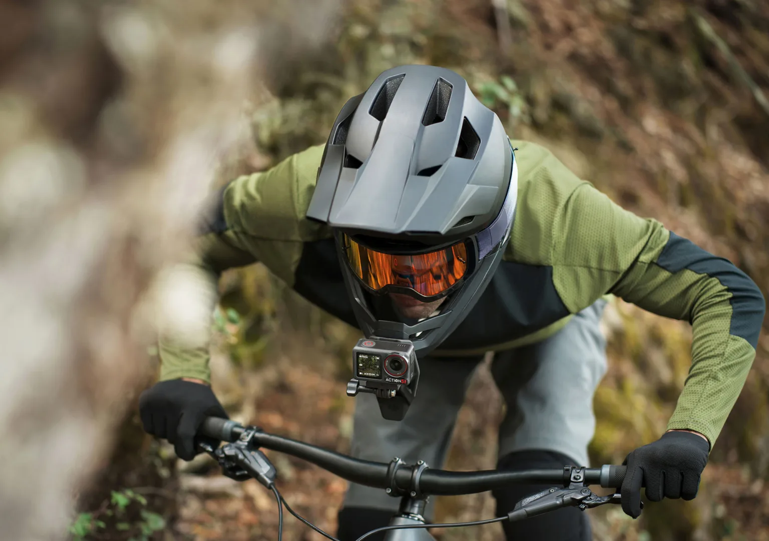 dji osmo action 5 pro action camera on downhill mountain biker's helmet.