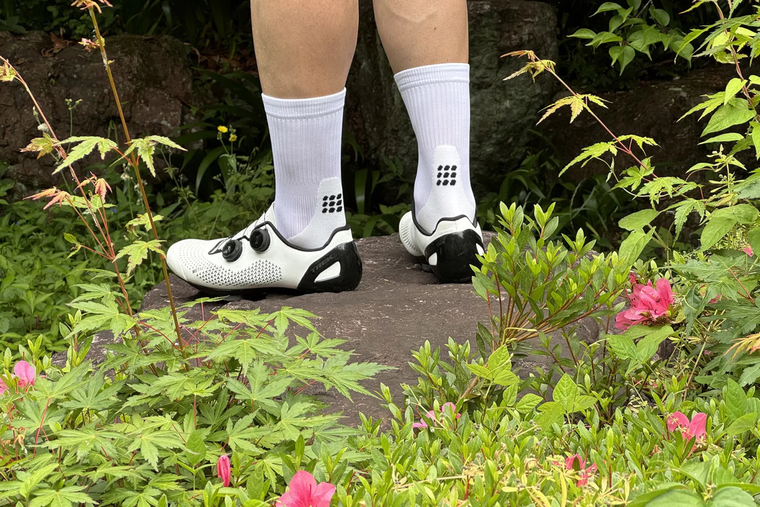 cep compression ultralight running cycling socks worn in a flower garden.