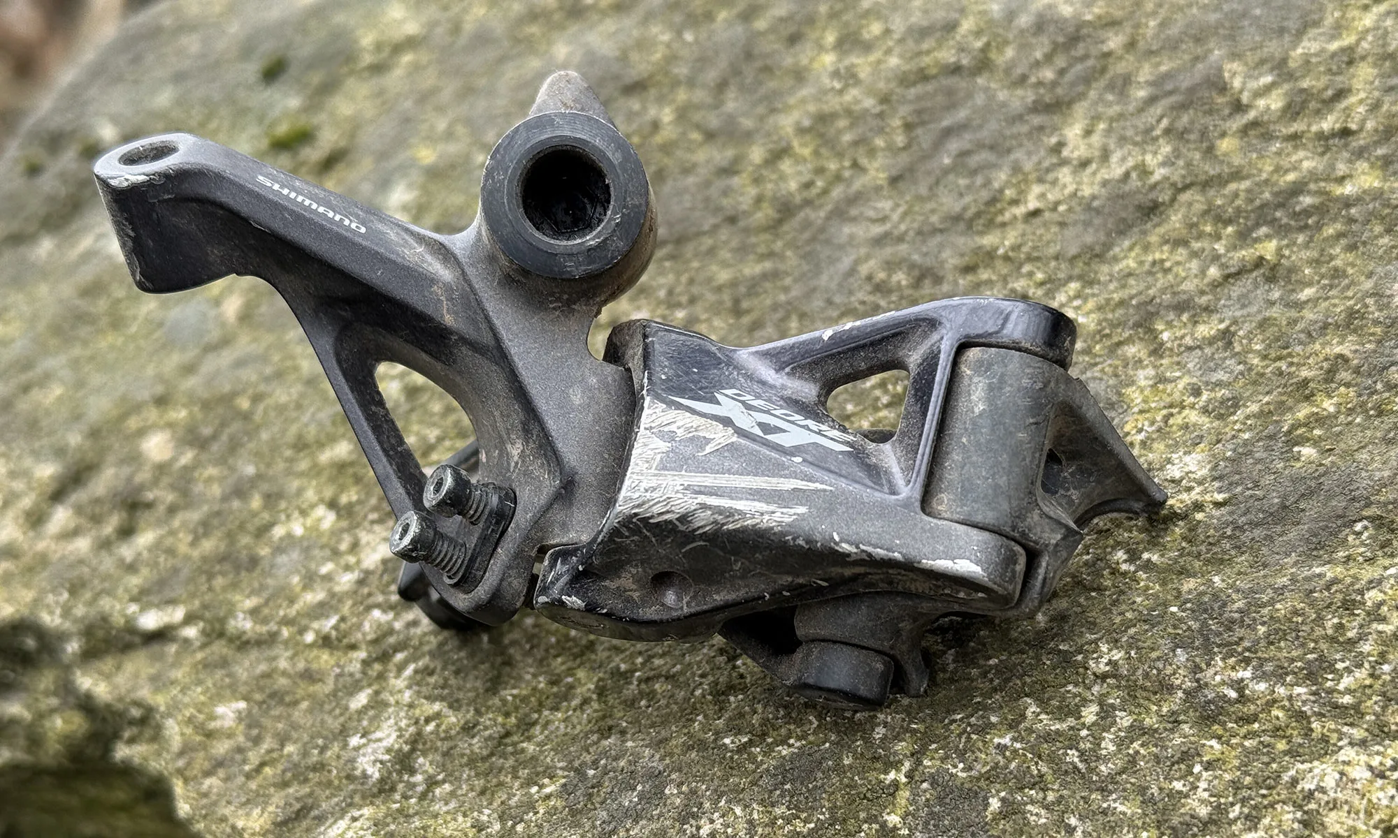 broken Shimano XT derailleur where the cage hung on a rock