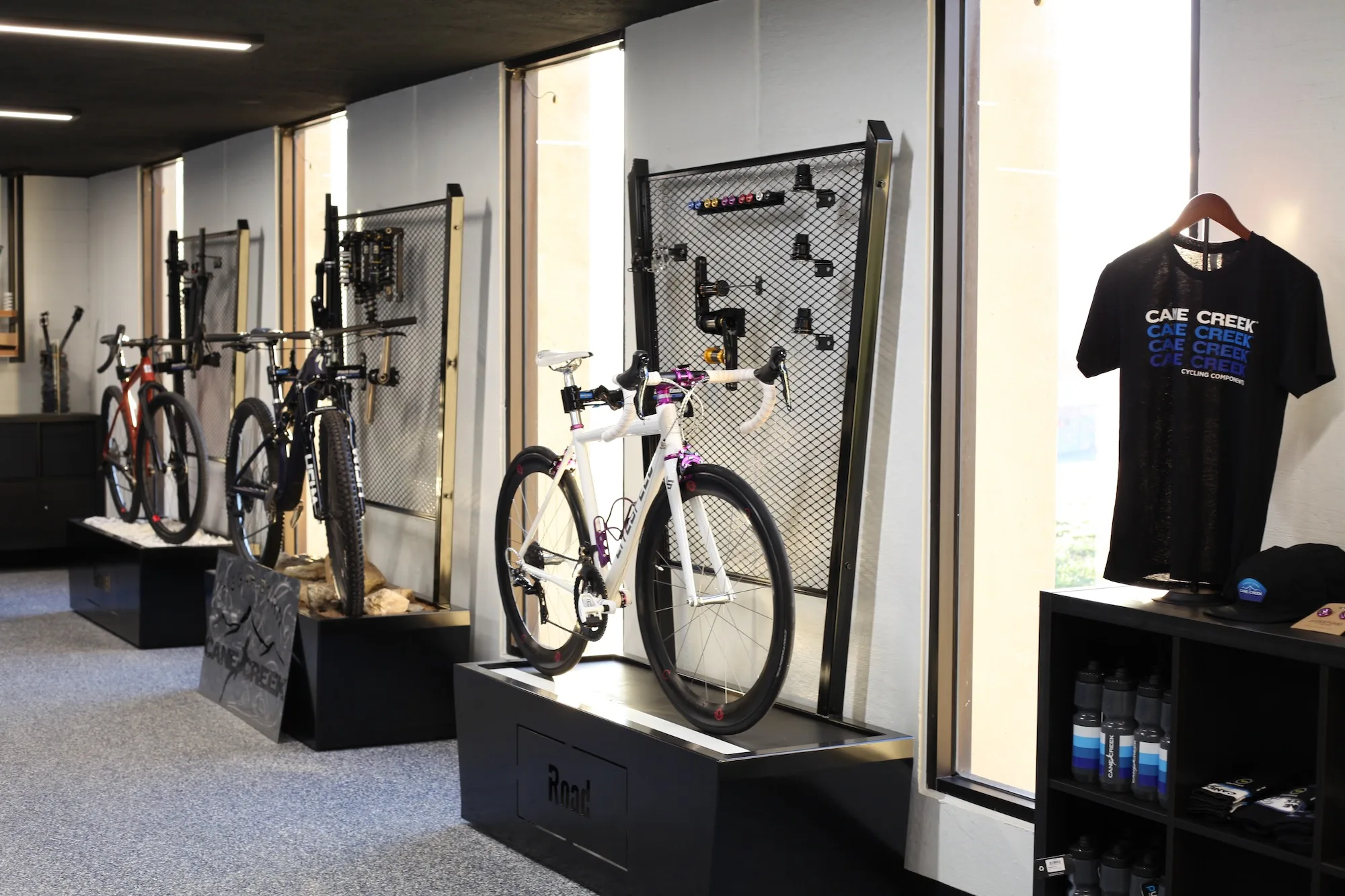 A display wall in the Cane Creek Experience Center with custom bikes and merchandise.
