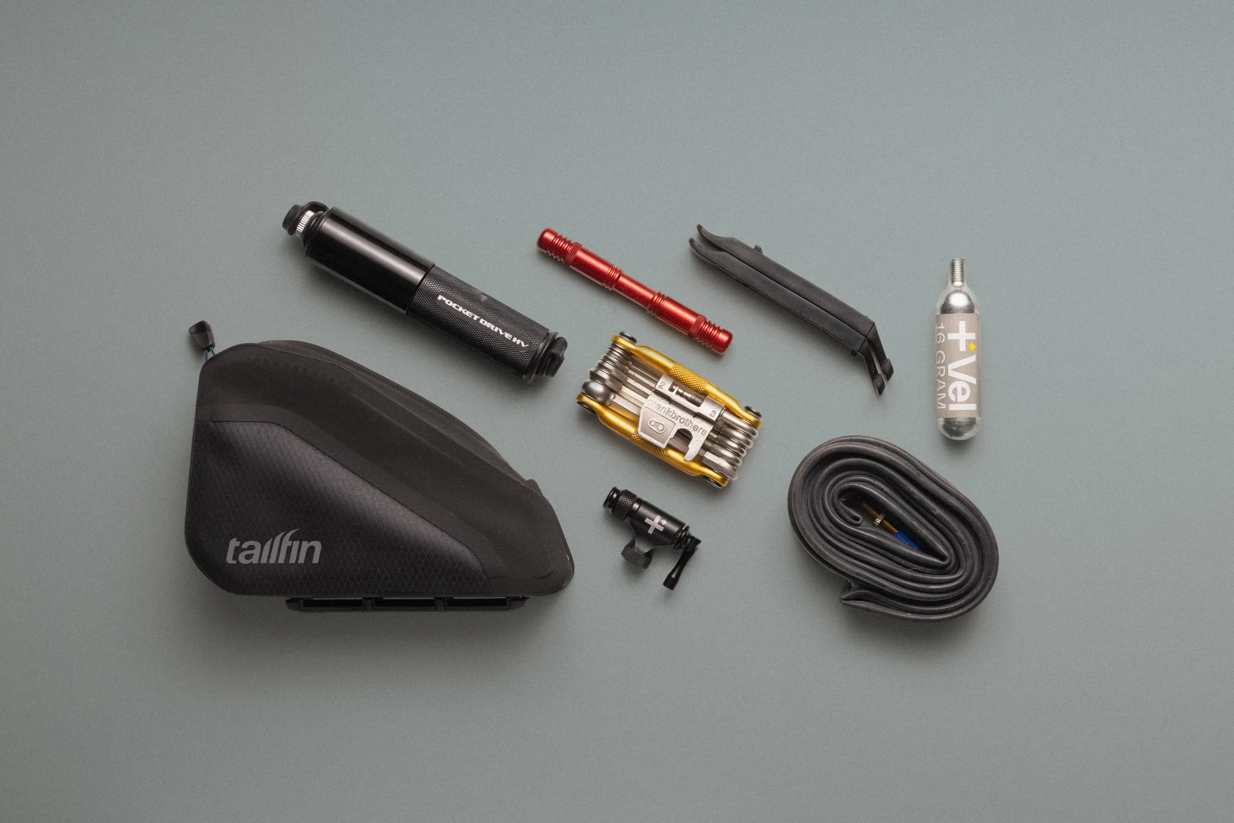 Tailfin's Rear Top Tube Bag shown next to an assortment of spares and tools.
