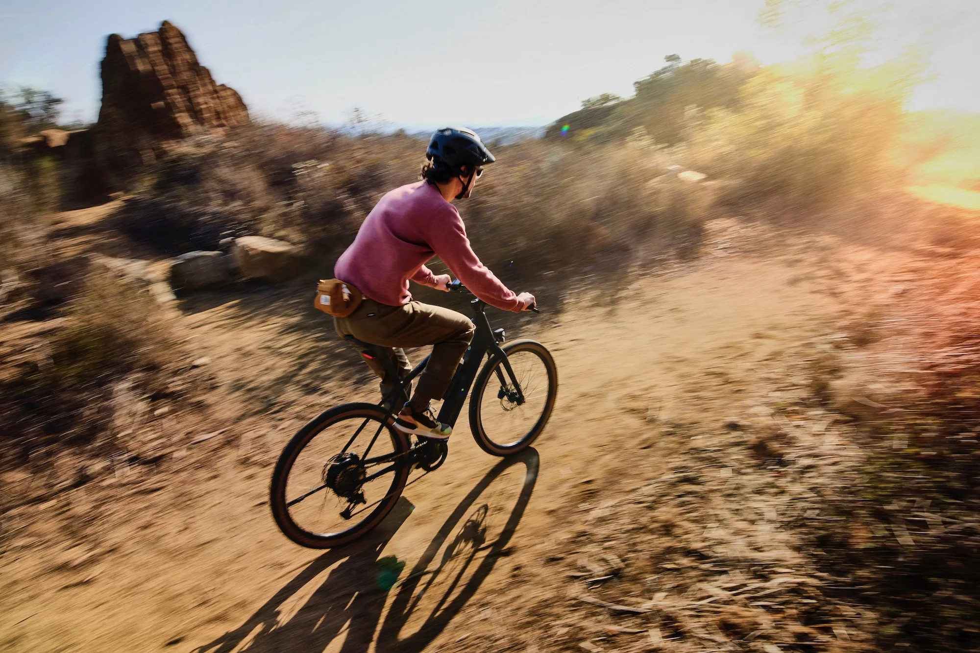 Riding the Trek FX+ 1 e-bike on a smooth unpaved path
