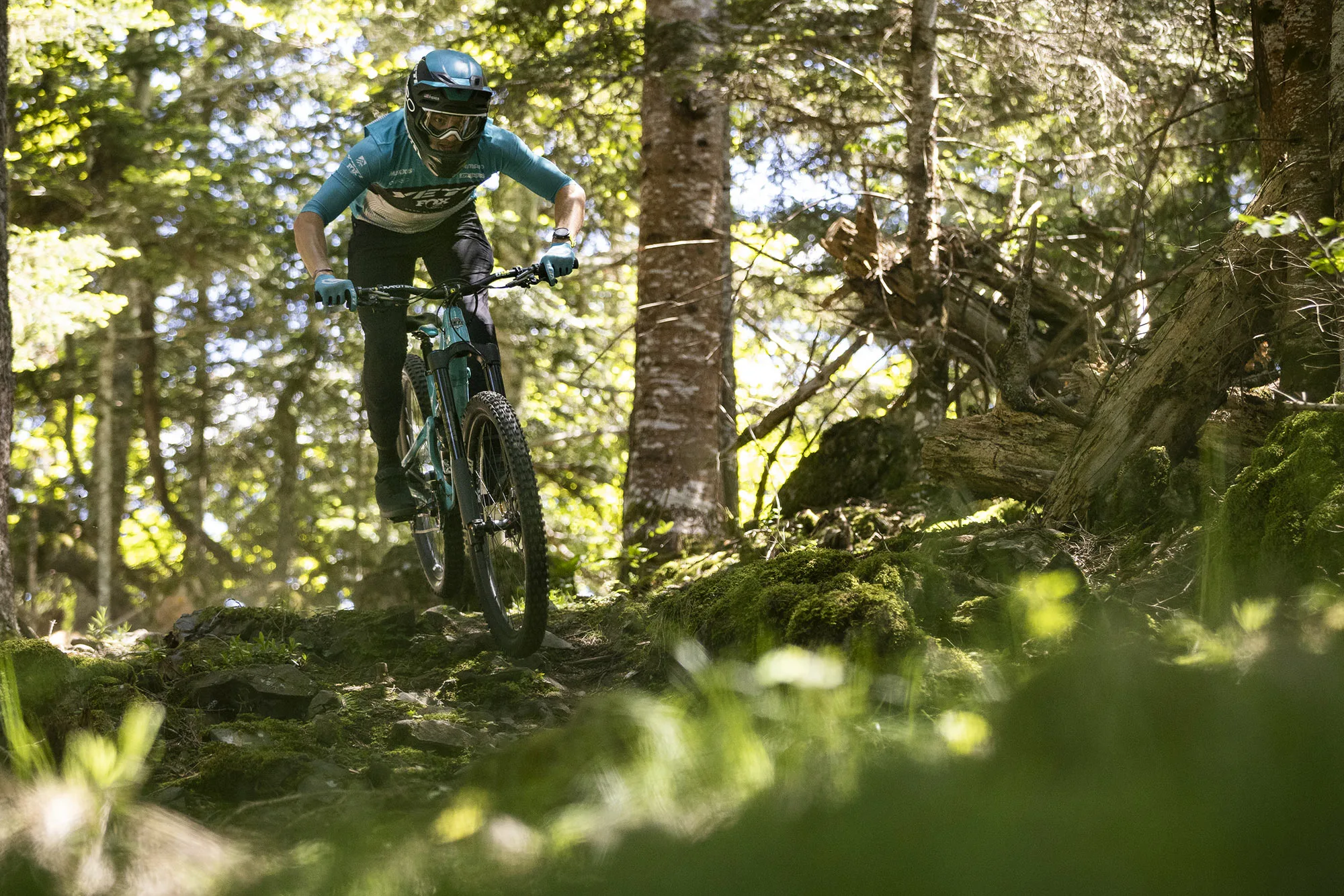 mountain biker racing on the new fox podium inverted enduro fork.