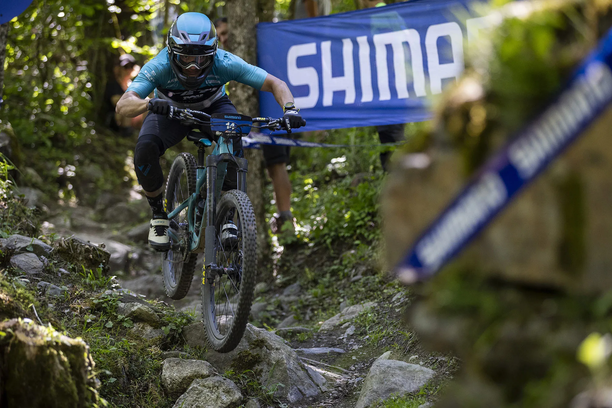 mountain biker racing on the new fox podium inverted enduro fork.
