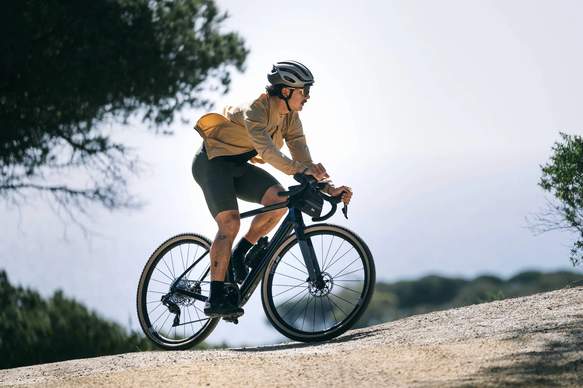 A rider on the Ridley E-ASTR going up a hill.
