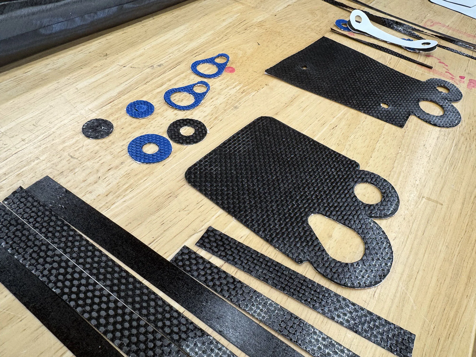 parlee factory work table with carbon fiber pieces used to make a road bike fork.