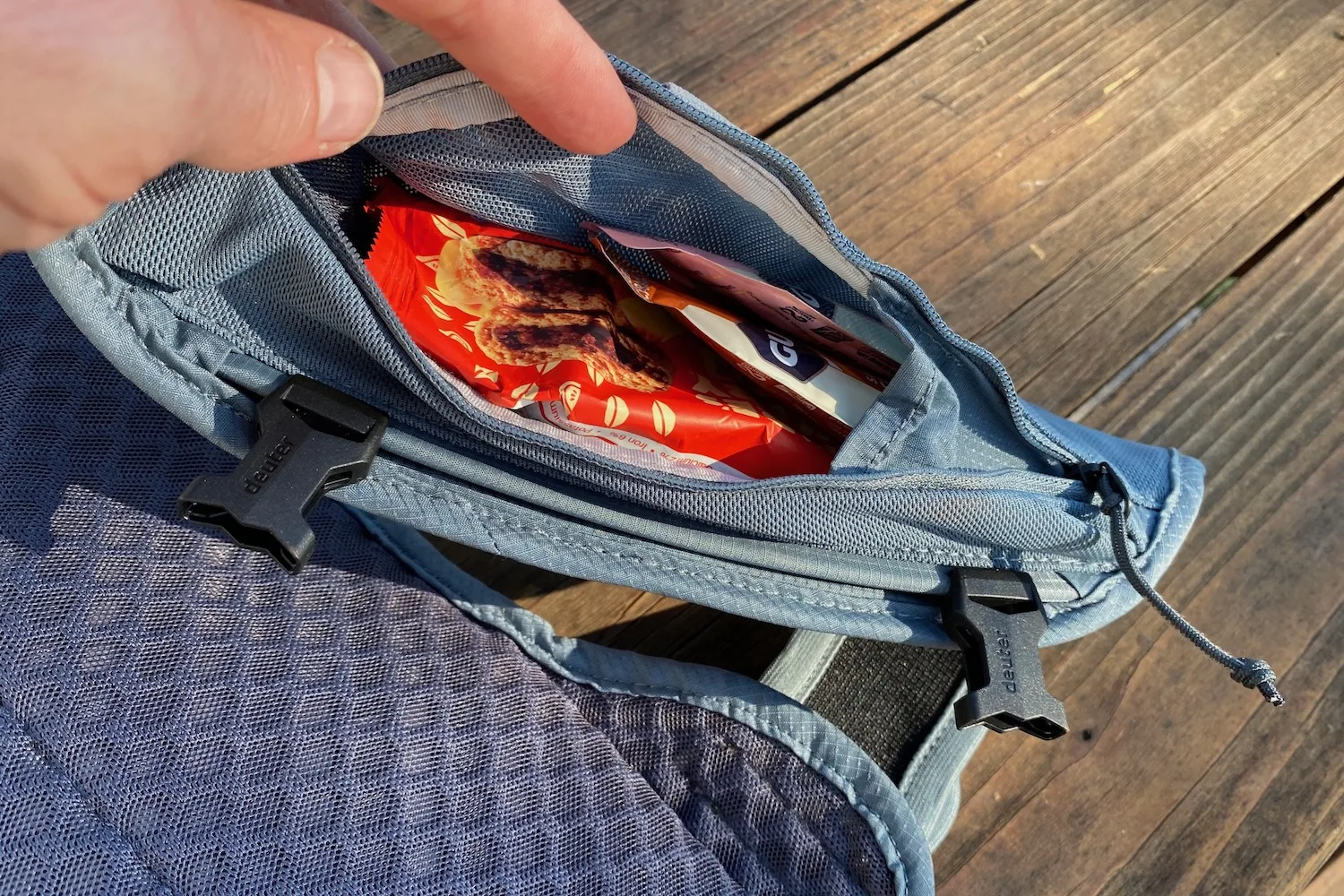 The zippered strap pocket with some snack inside