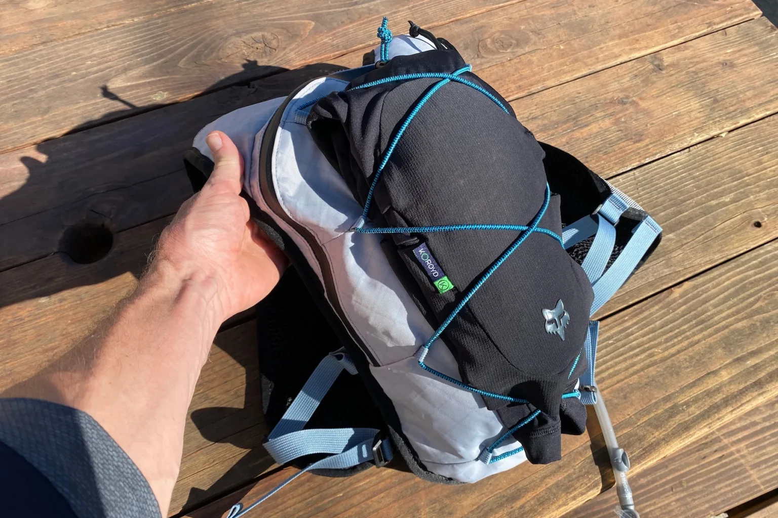 Knee pads strapped to the outside of the Supernatural pack with the bungee