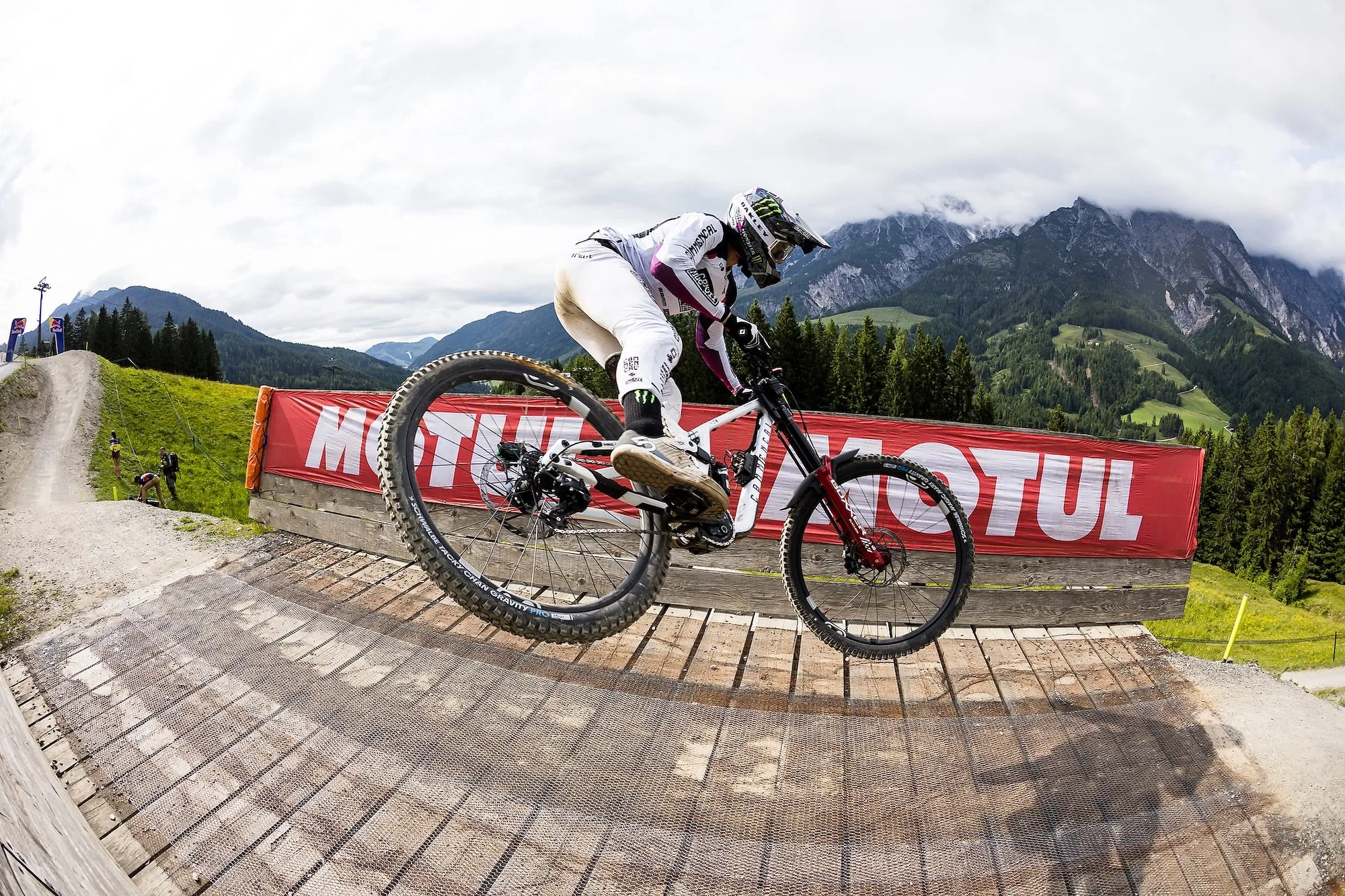 A world cup downhill racer riding with an Ochain spider on their bike
