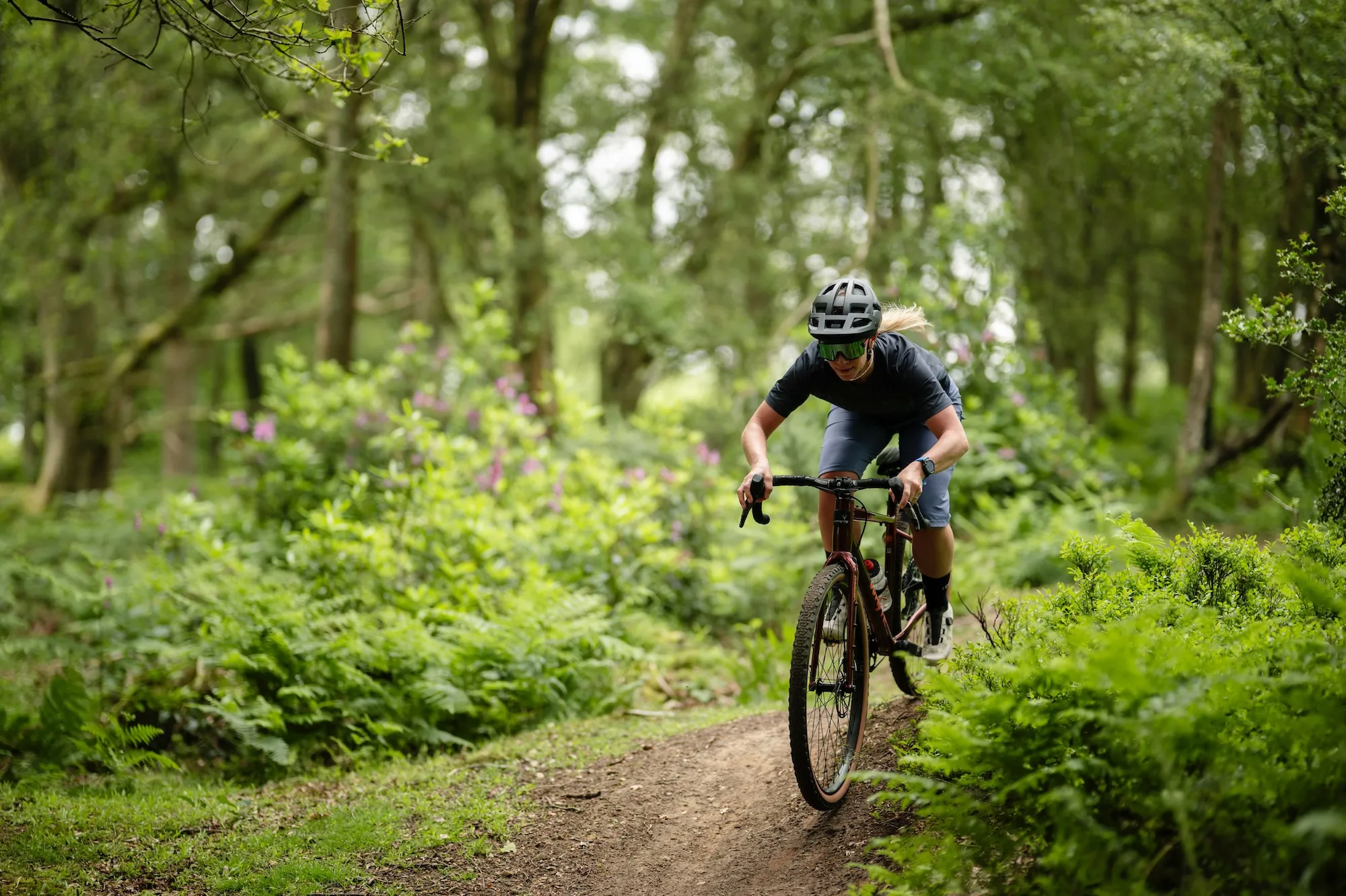 A female rider on the Whyte Verro riding a singletrack trail