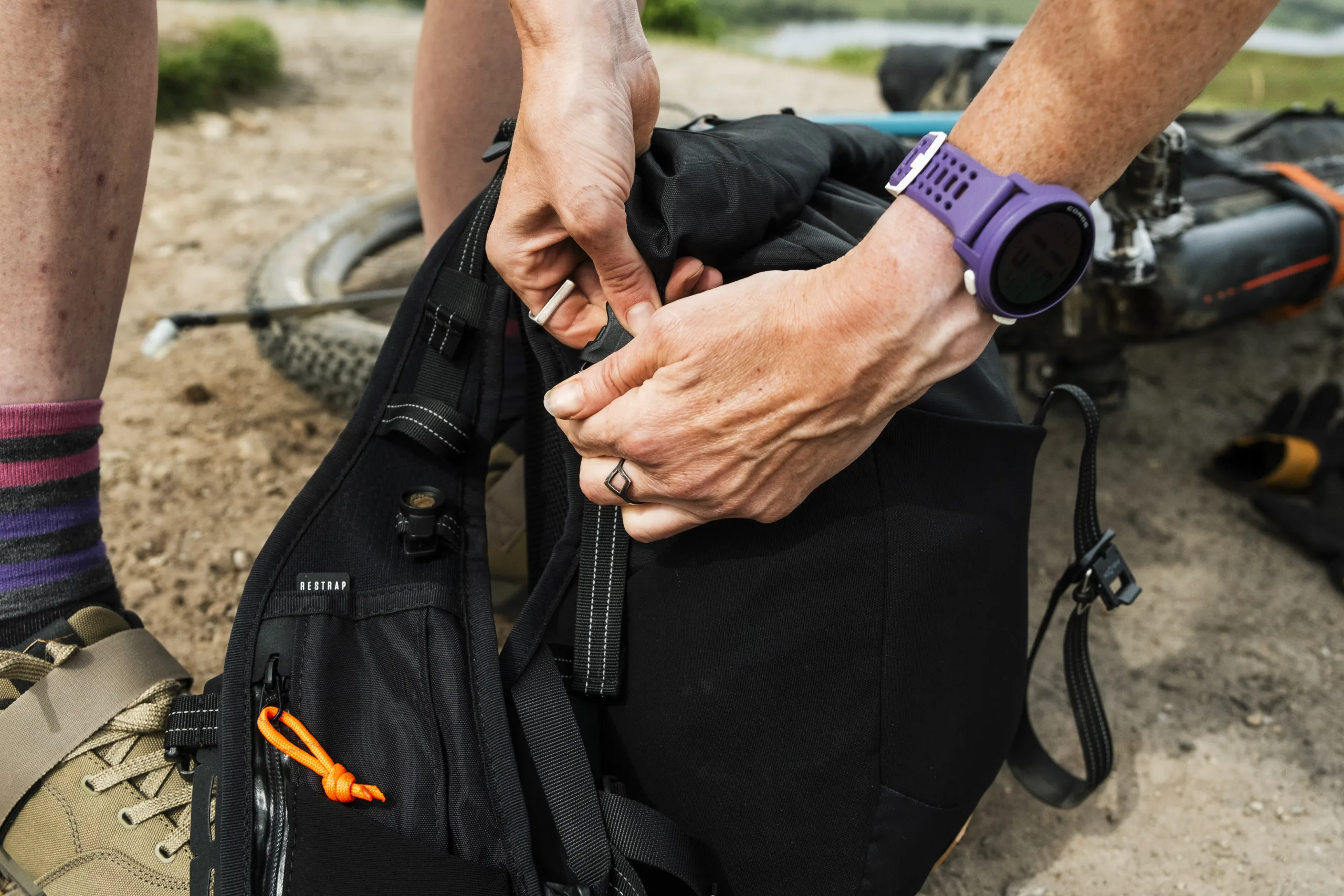 a rider adjusting straps on their Restrap Rolltop Hydration Vest
