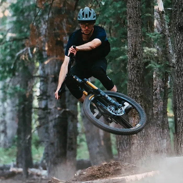 A biker hitting a jump while wearing the new Montaro Mips 3 helmet
