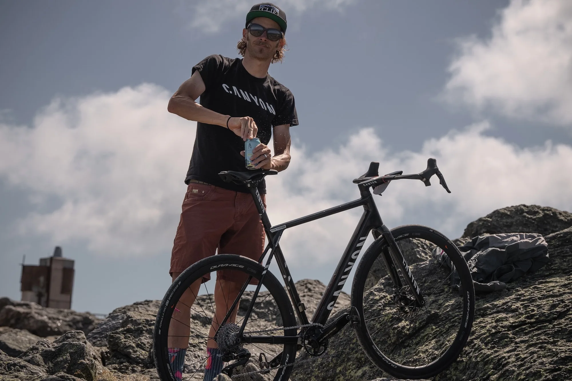 Pete opening a non-alcoholic beer next to his hill climb bike