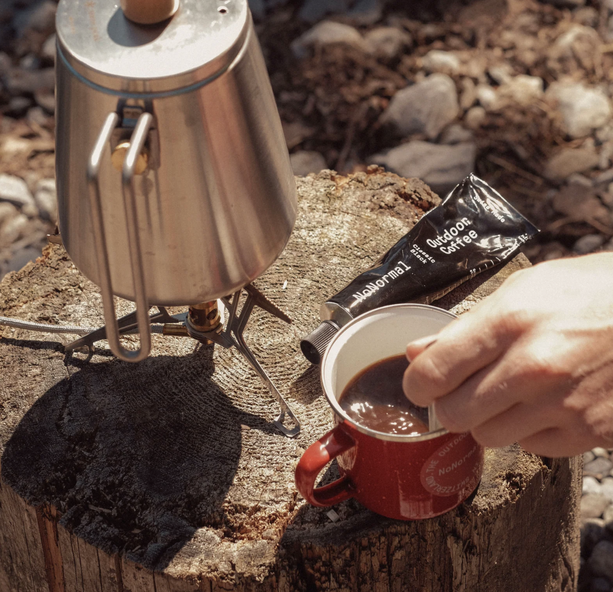 a person stirring NoNormal Coffee Paste into water