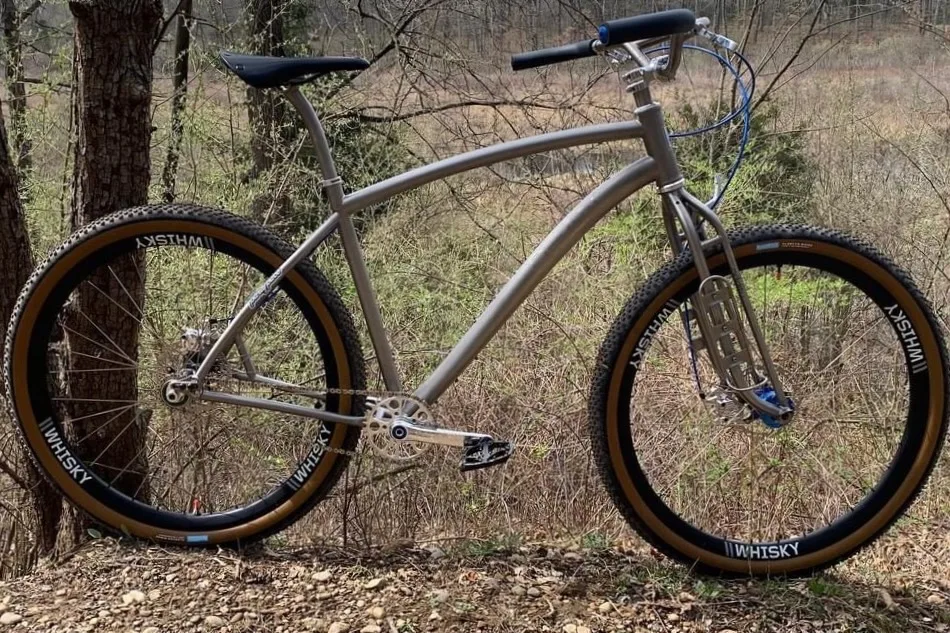 A titanium framed bike with a complex fork design