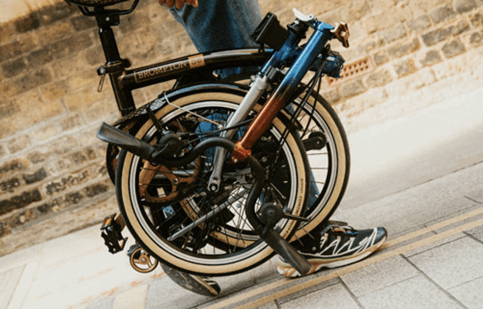Brompton 1975 folded up and carried down the street