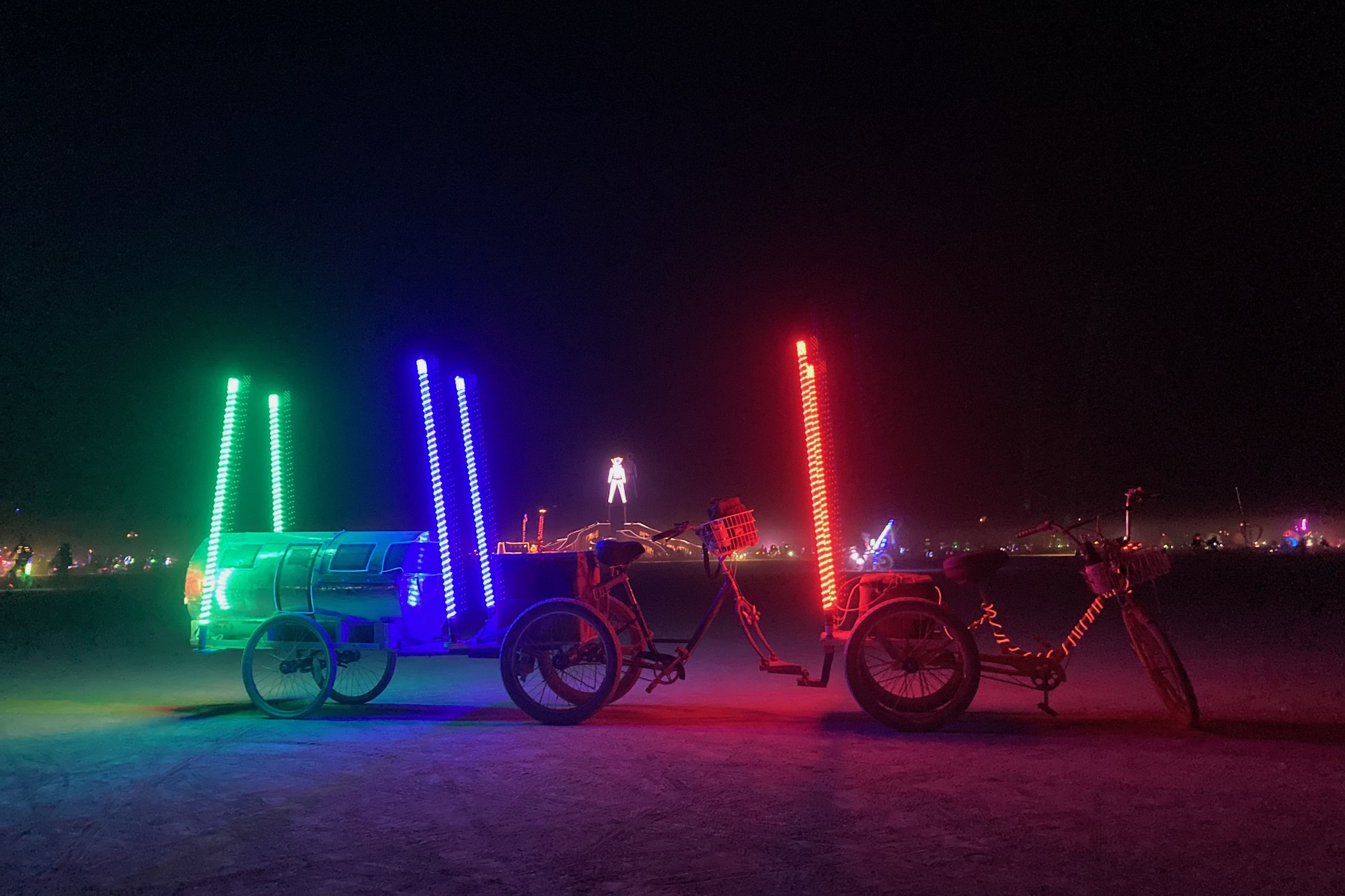 picture of Emily's bikes at night with their custom "airstream" trailer for their son to sleep in.