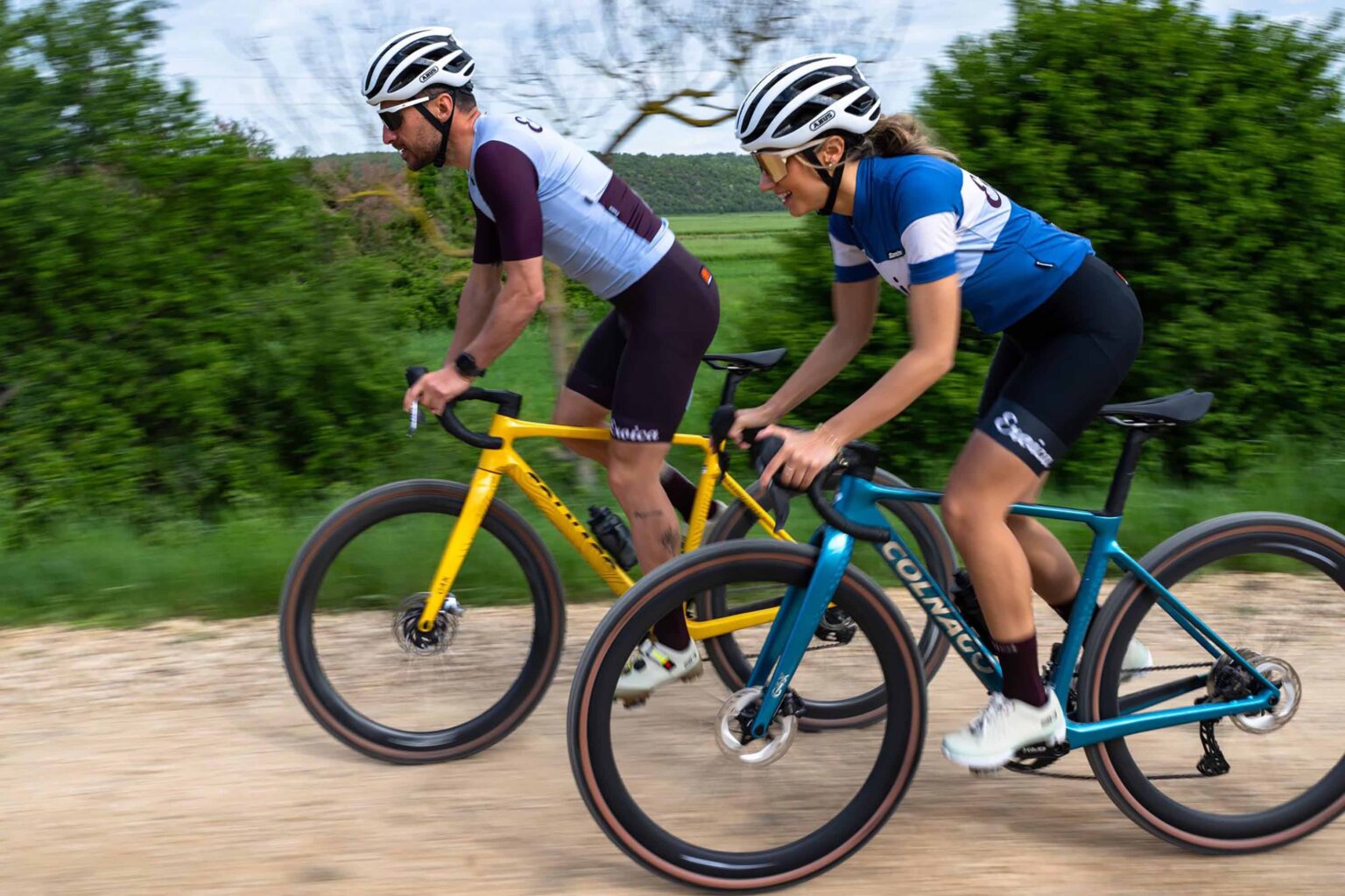 a man and a woman riding in santini x eroica apparel