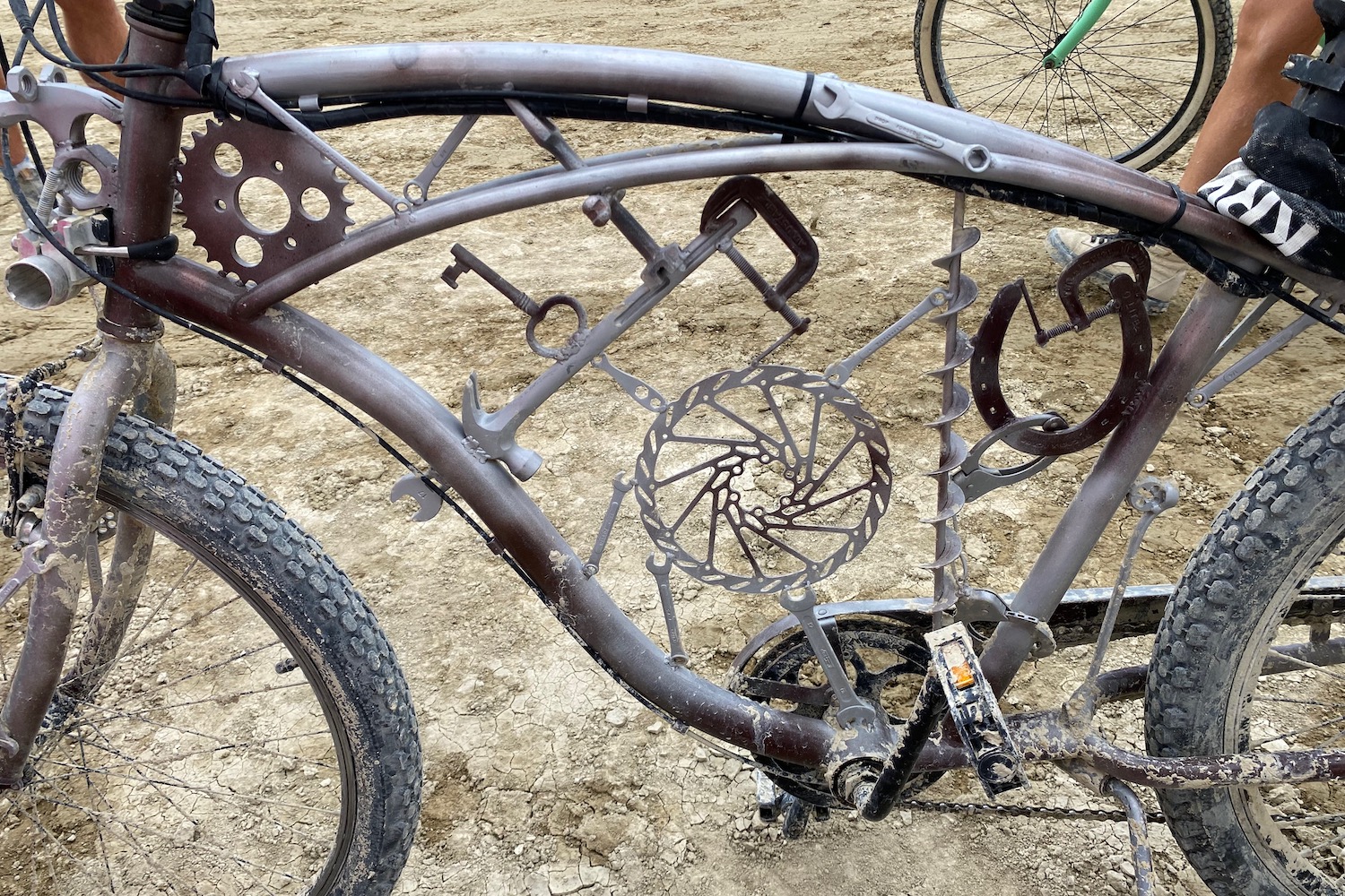 A bunch of tools and bike parts welded inside of a cruiser bike frame.