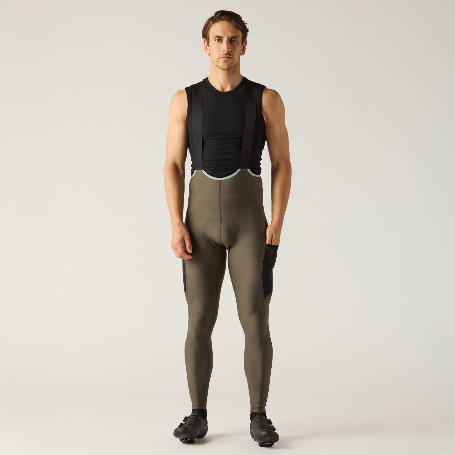 studio image of a man wearing the LUXE thermal bib tights