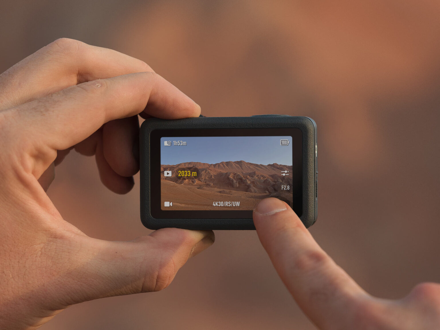 hands pressing on touchscreen of dji osmo action 6.