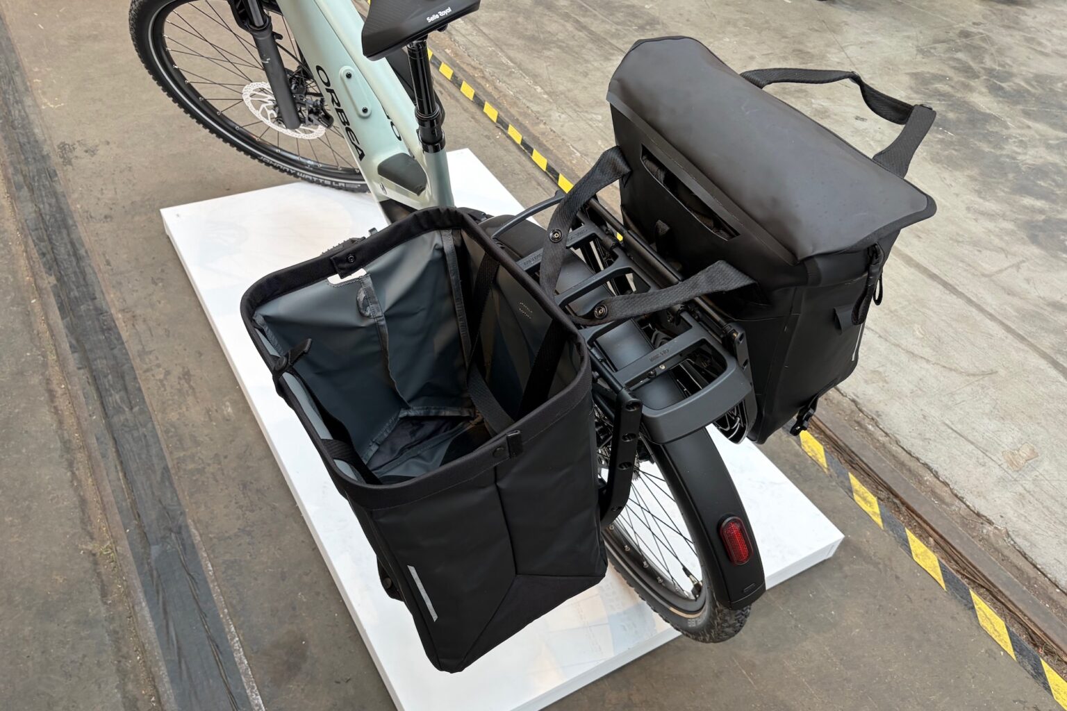 2 Inlock pannier bags mounted on a bike, with the cargo one opened