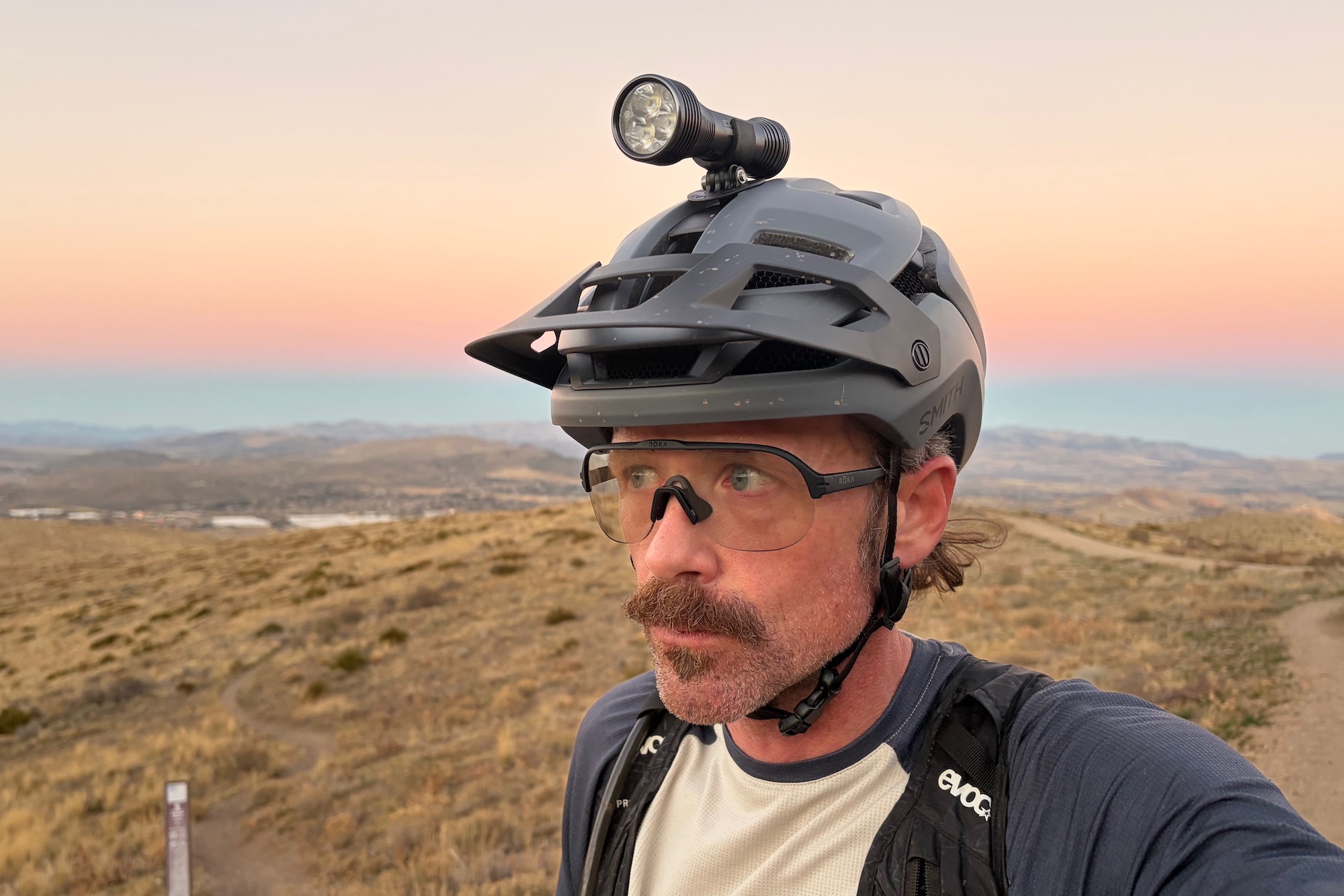 wearing the Roka San Remo sunglasses as the sun is setting with a bike light on the head.