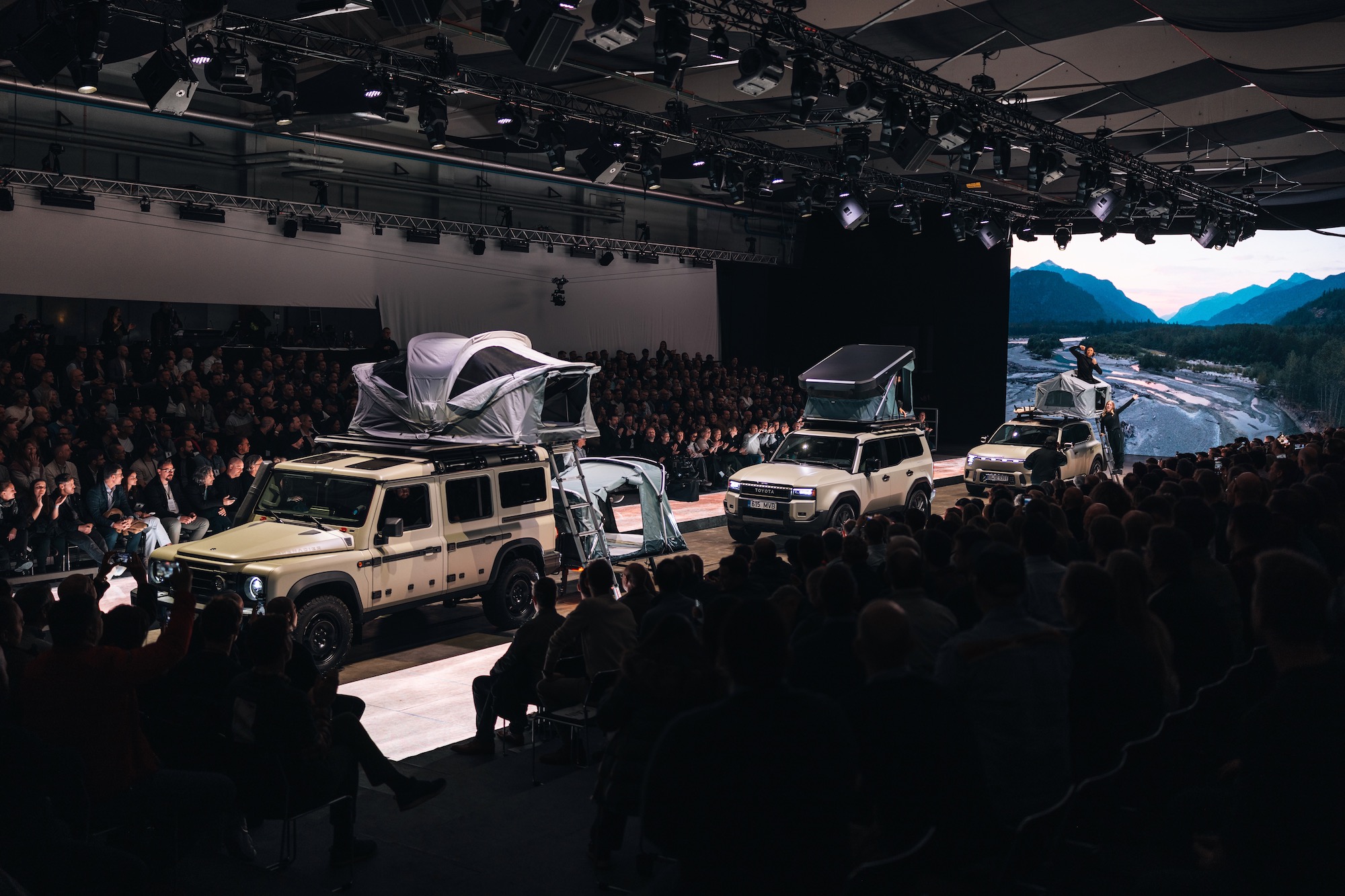 three vehicles each carrying one of Thule's rooftop tents in the runway show.