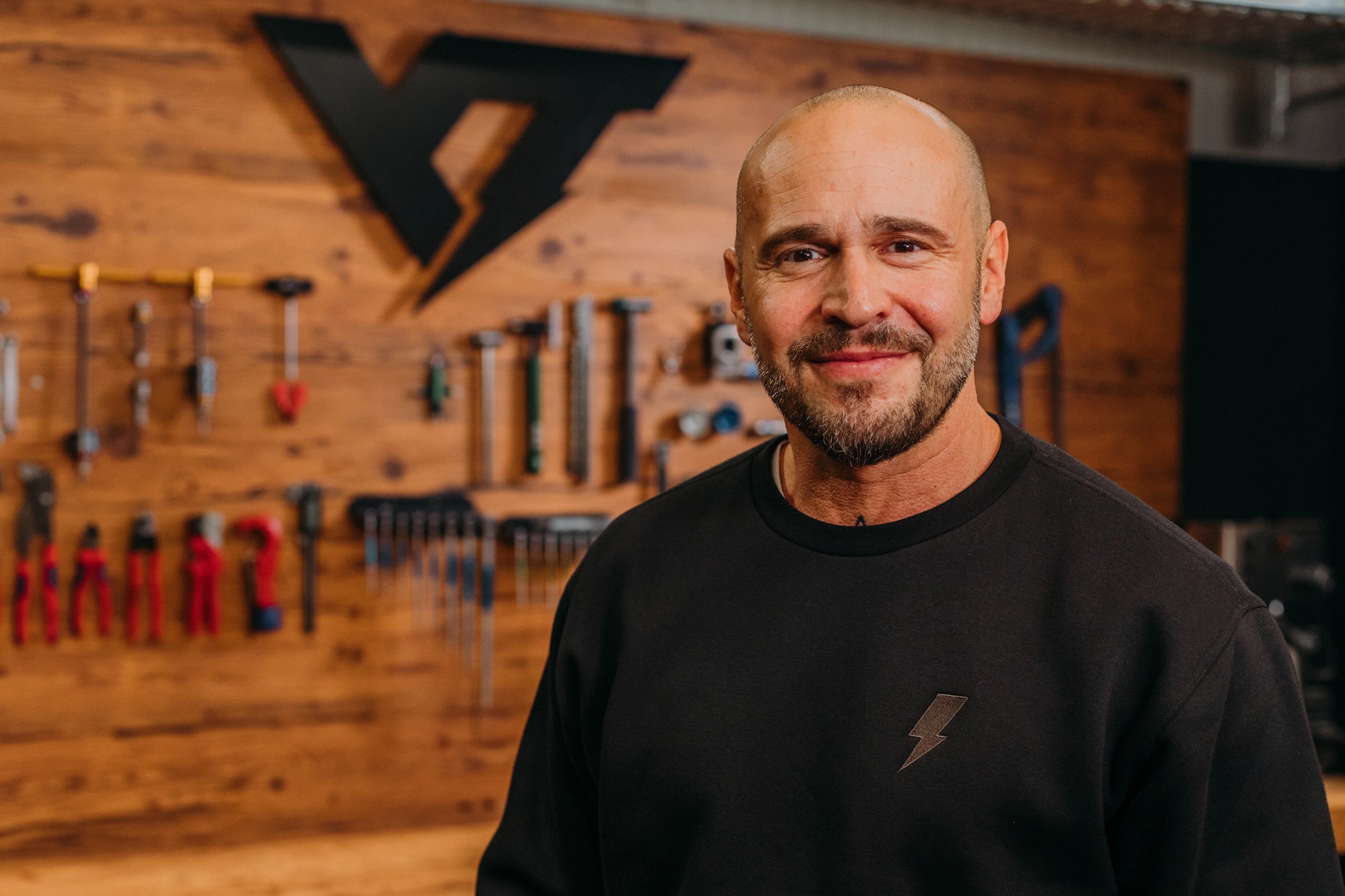Markus Flossman sitting in front of a bike work bench.