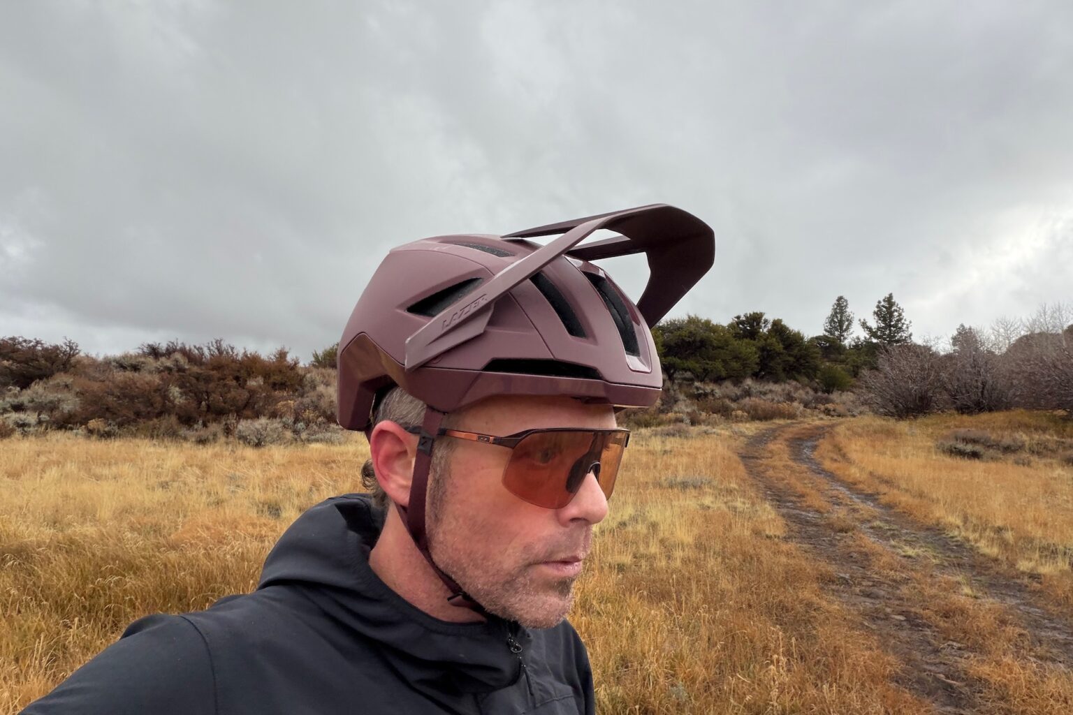 wearing the Impala KinetiCore helmet with the visor in the high/up position.