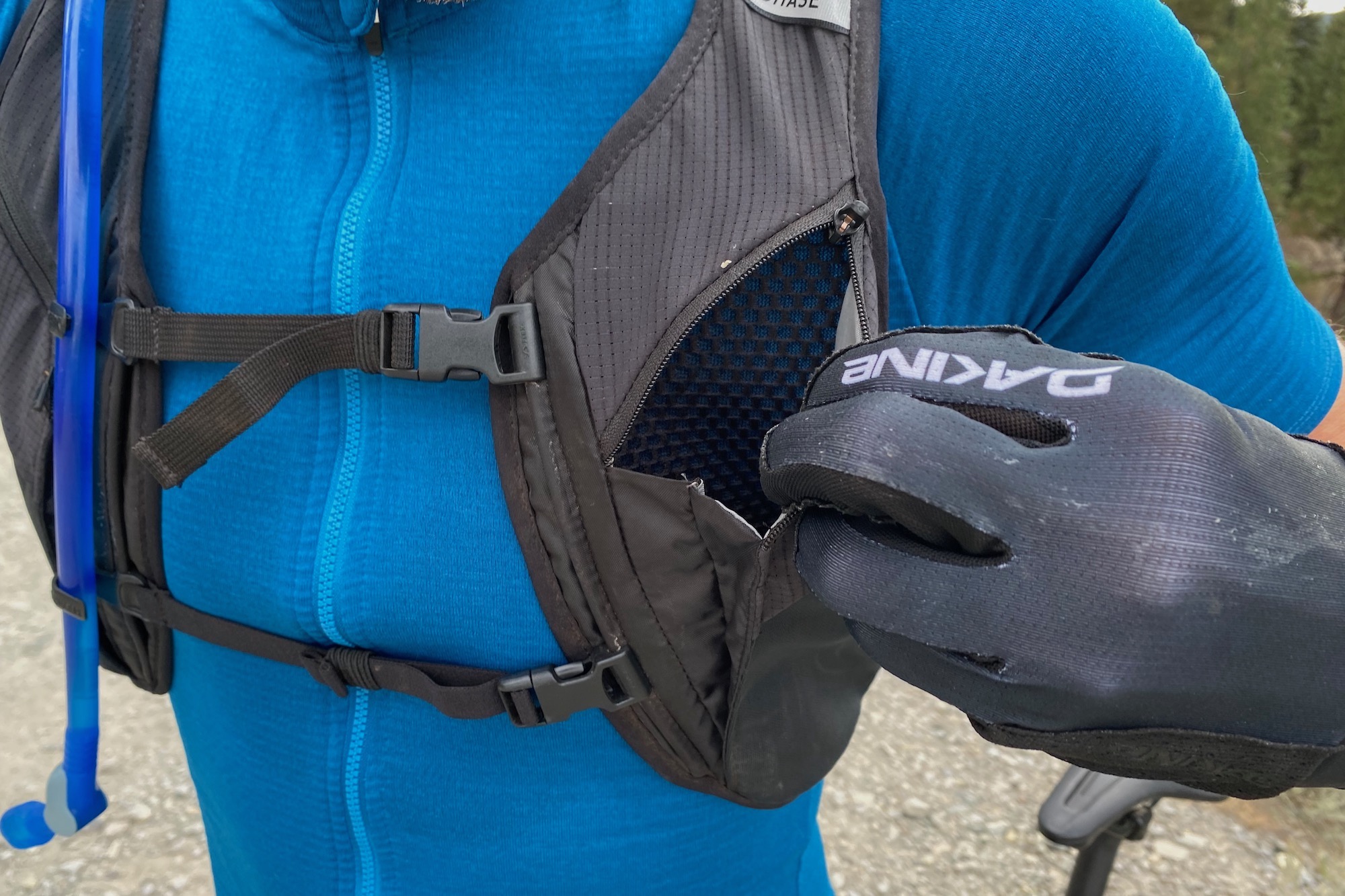 Opening the zippered chest pocket to show its size