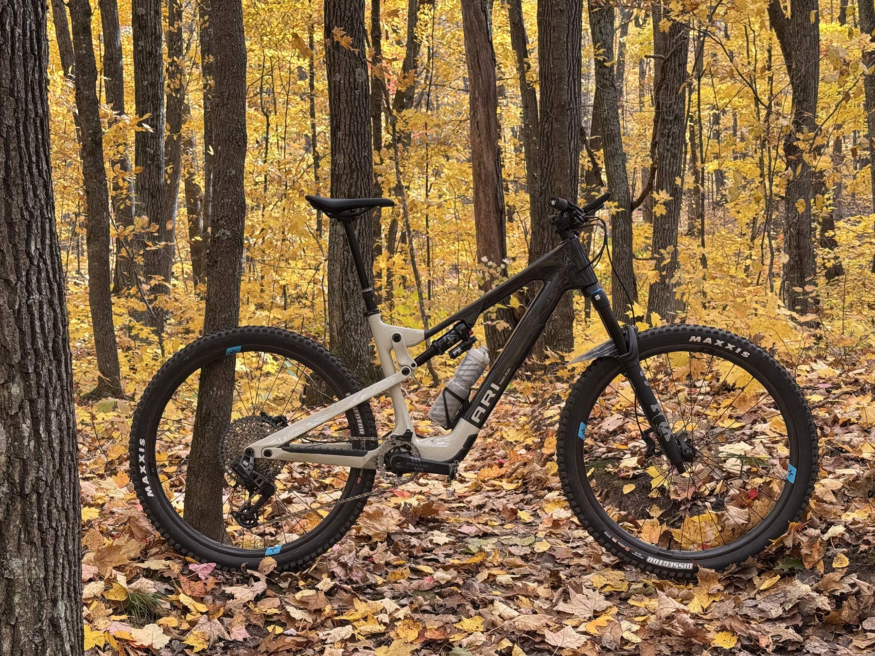 ari nebo peak lightweight e-mountain bike shown in the forest with yellow leaves.