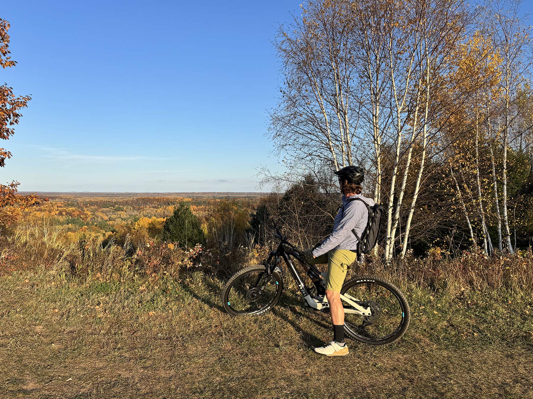 mountain biker overlooking mt telemark village mountain bike trails in cable wisconsin.