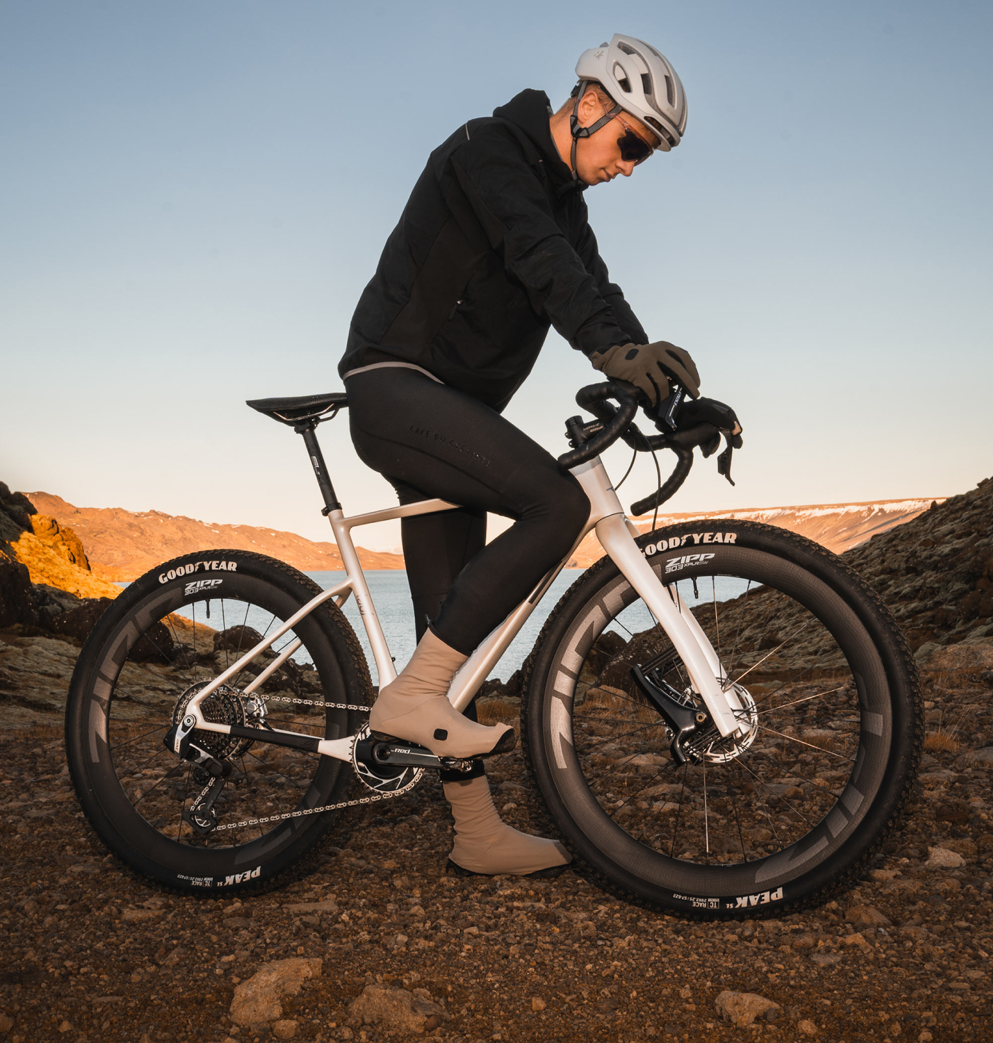 rider straddling a white lauf seigla gravel bike.