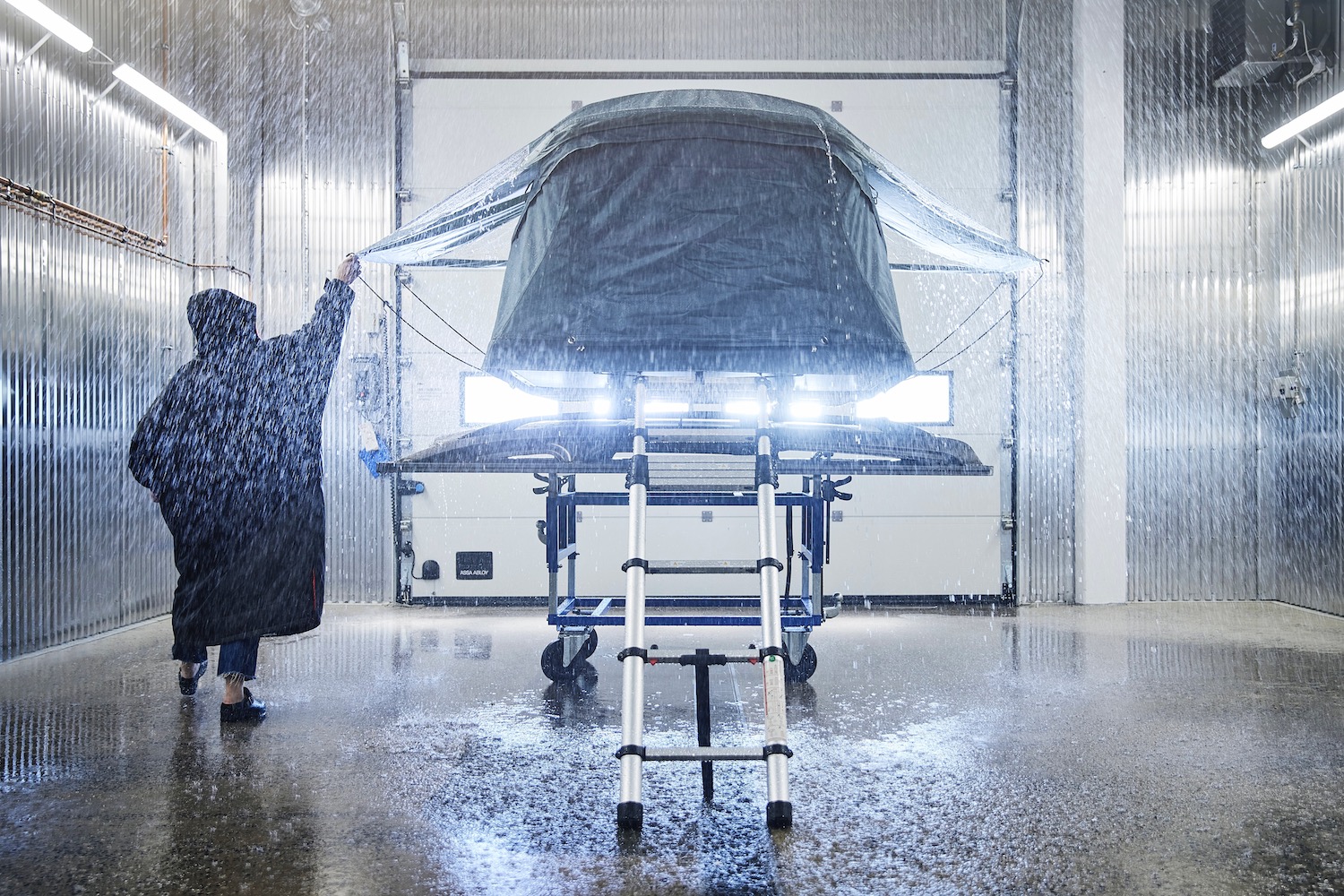 testing a roof top tent in Thule's rain simulator