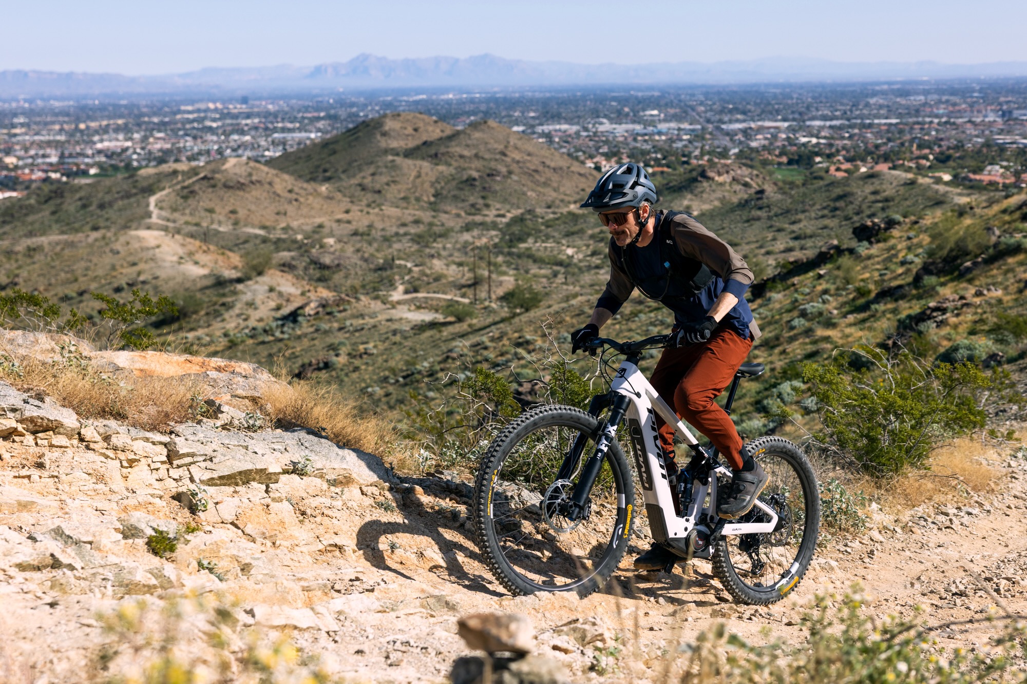 climbing a steep, rock trail on the Pivot Shuttle LT