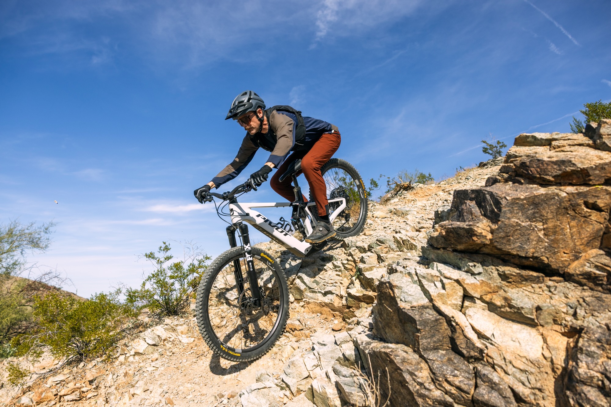 riding the shuttle lT over a steep rocky drop off on South Mountain