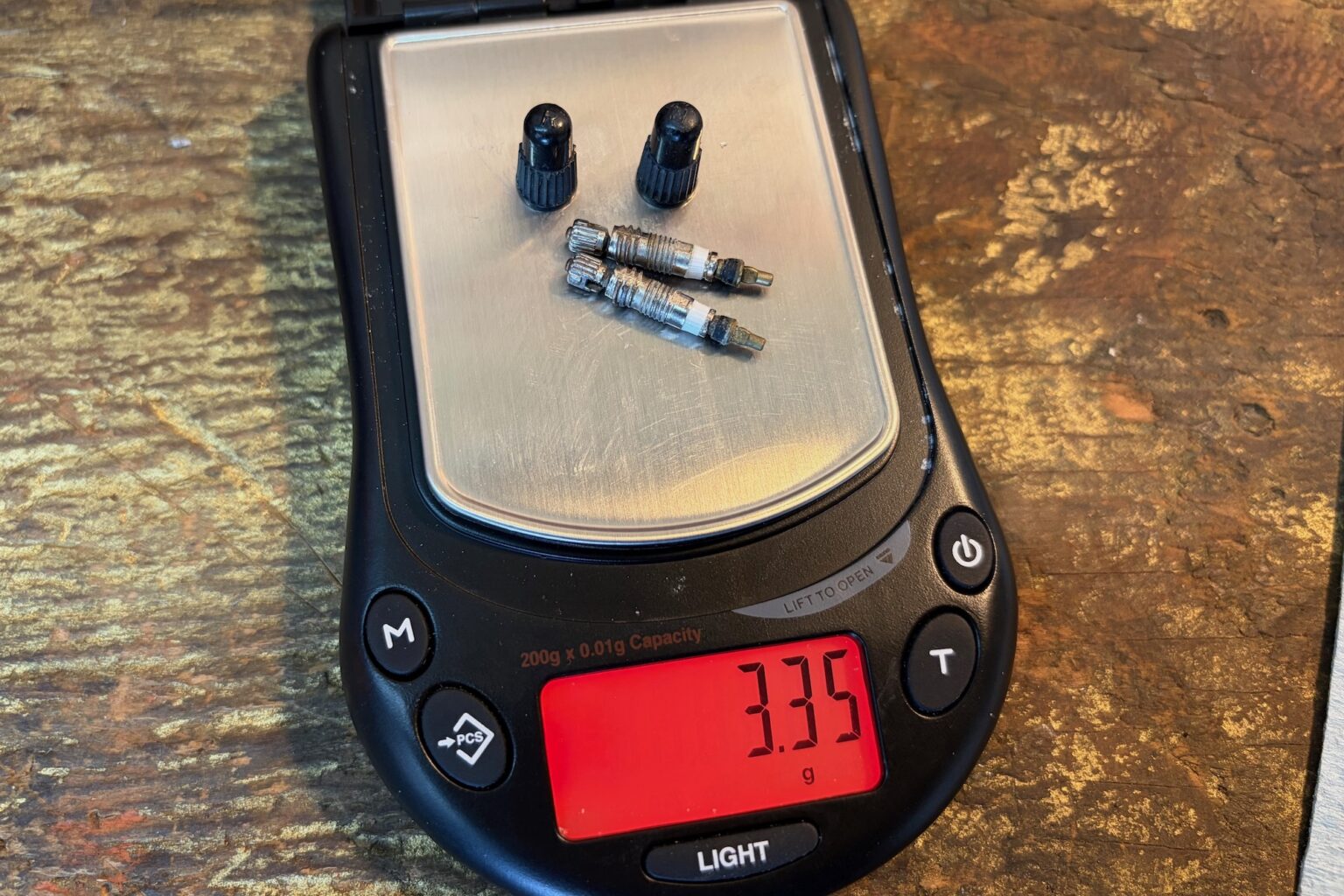 presta valves on a scale showing a weight of 3.35 grams
